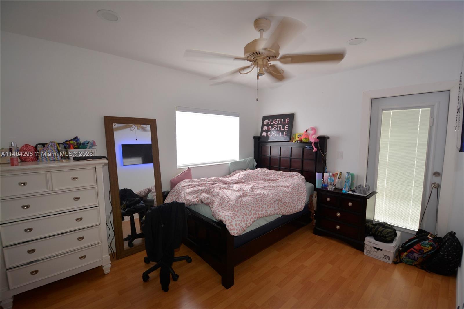 10915 Southwest 25th Street, Unit 2 Miami, FL 33165 - Photo 24 of 28 a bedroom with a bed and a chandelier