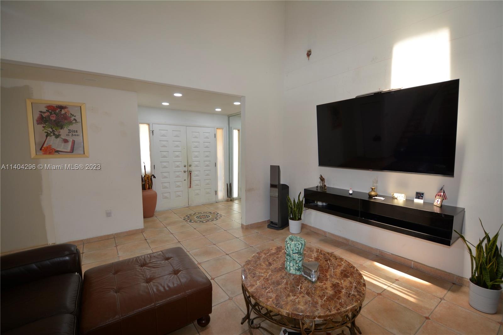 10915 Southwest 25th Street, Unit 2 Miami, FL 33165 - Photo 6 of 28 a living room with furniture and a flat screen tv