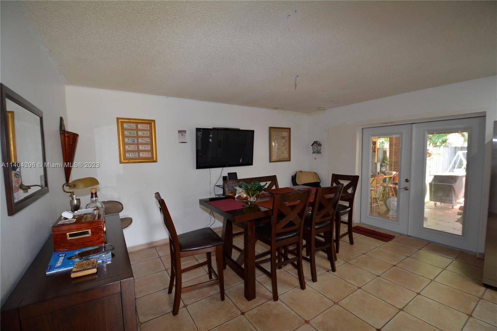 10915 Southwest 25th Street, Unit 2 Miami, FL 33165 - Photo 7 of 28 a view of a livingroom with furniture and a flat screen tv