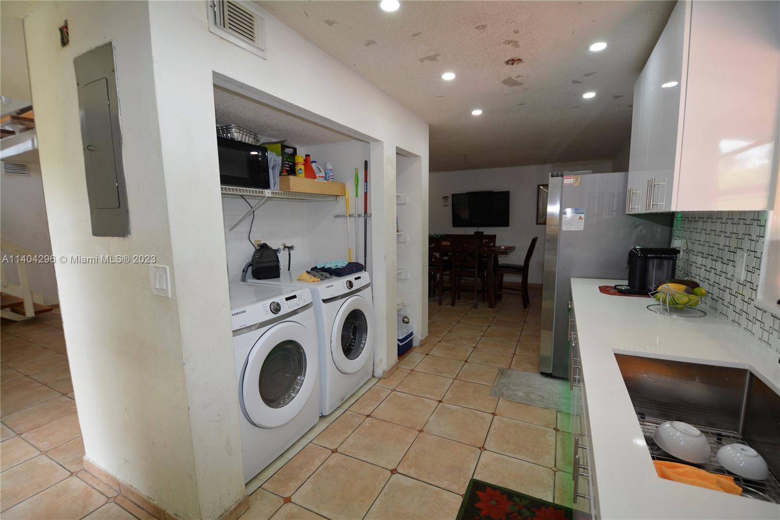 10915 Southwest 25th Street, Unit 2 Miami, FL 33165 - Photo 9 of 28 a kitchen with a refrigerator and a stove top oven