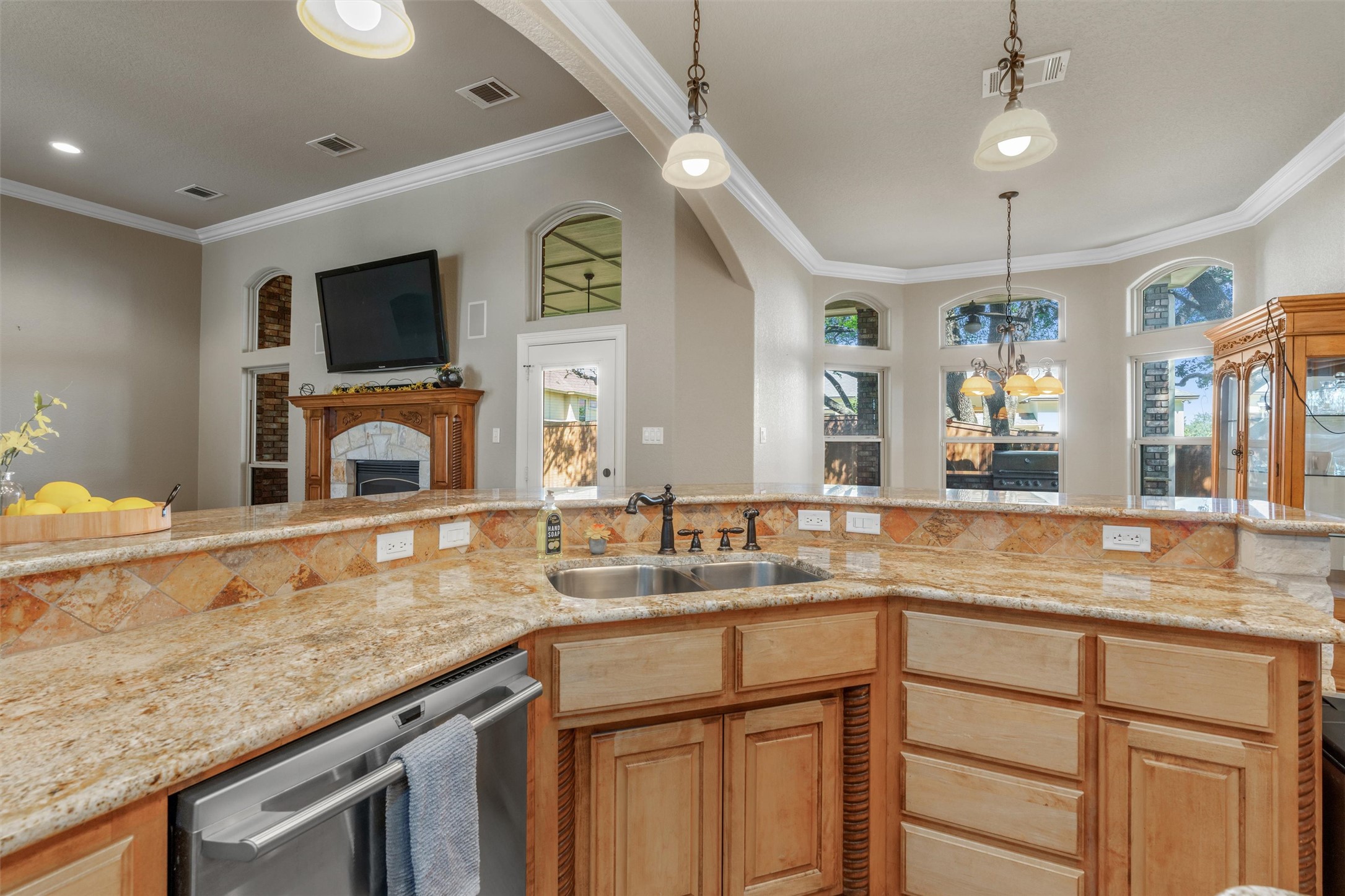8006 Ridgeway Court Nolanville, TX 76559 - Photo 40 of 40 Kitchen featuring a fireplace, dishwasher, light stone counters, crown molding, and open floor plan
