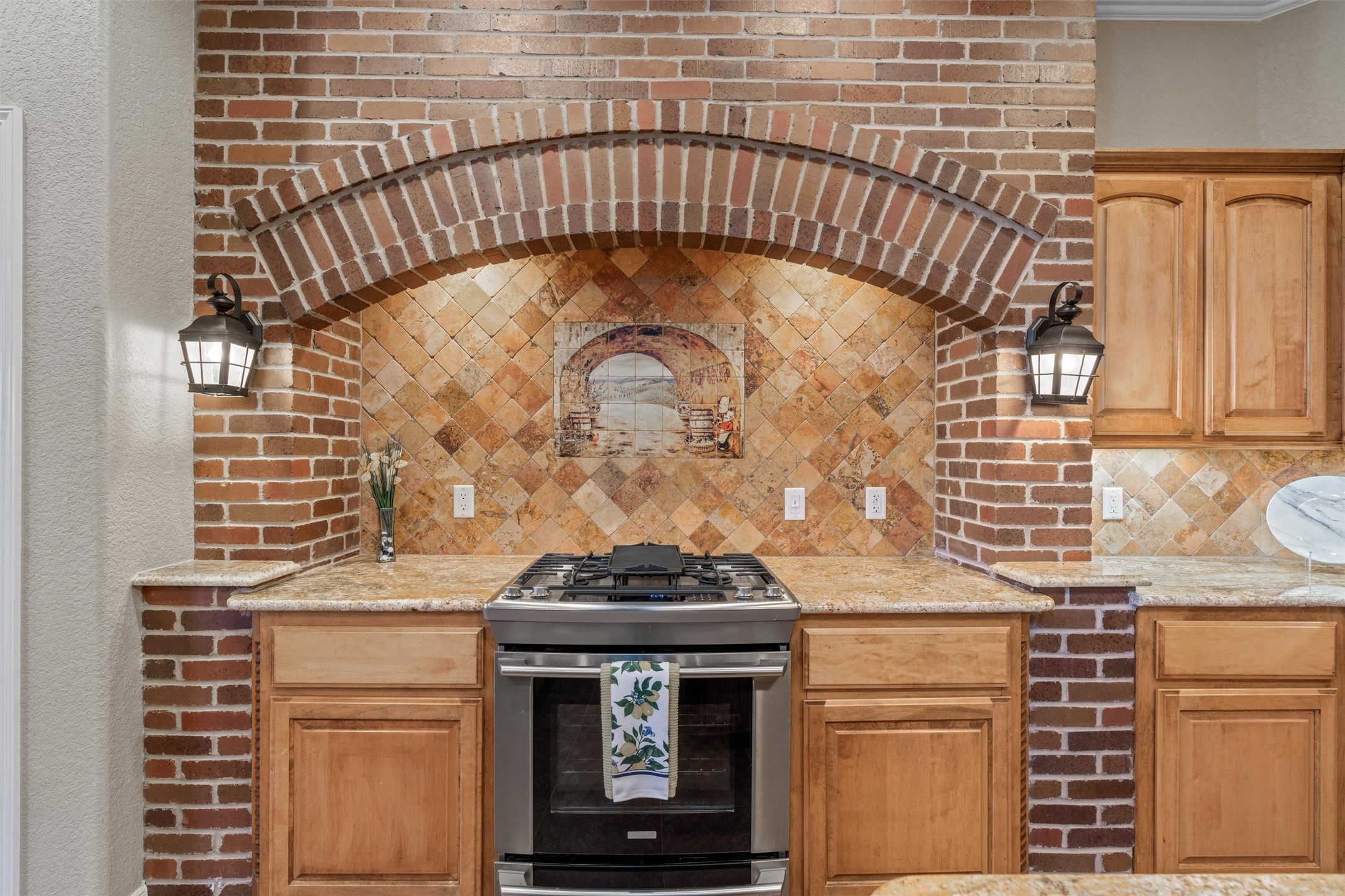 8006 Ridgeway Court Nolanville, TX 76559 - Photo 19 of 40 Kitchen featuring gas range, light stone counters, and tasteful backsplash