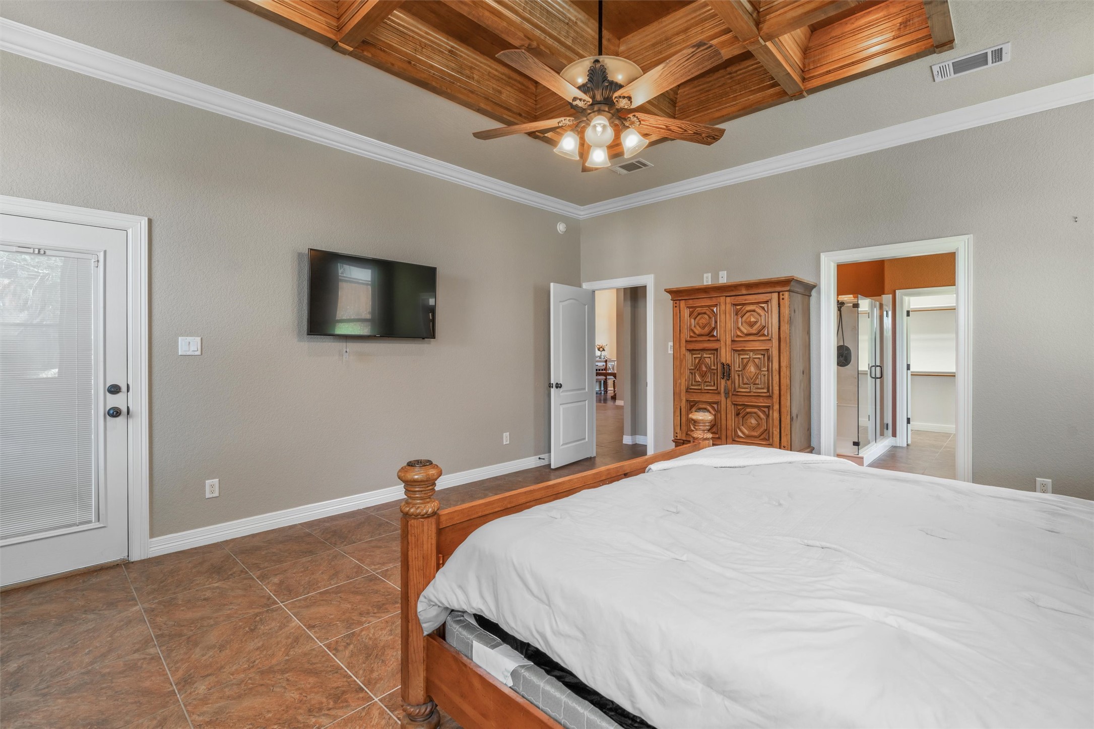 8006 Ridgeway Court Nolanville, TX 76559 - Photo 22 of 40 Bedroom featuring ornamental molding, coffered ceiling, a ceiling fan, and dark tile patterned floors