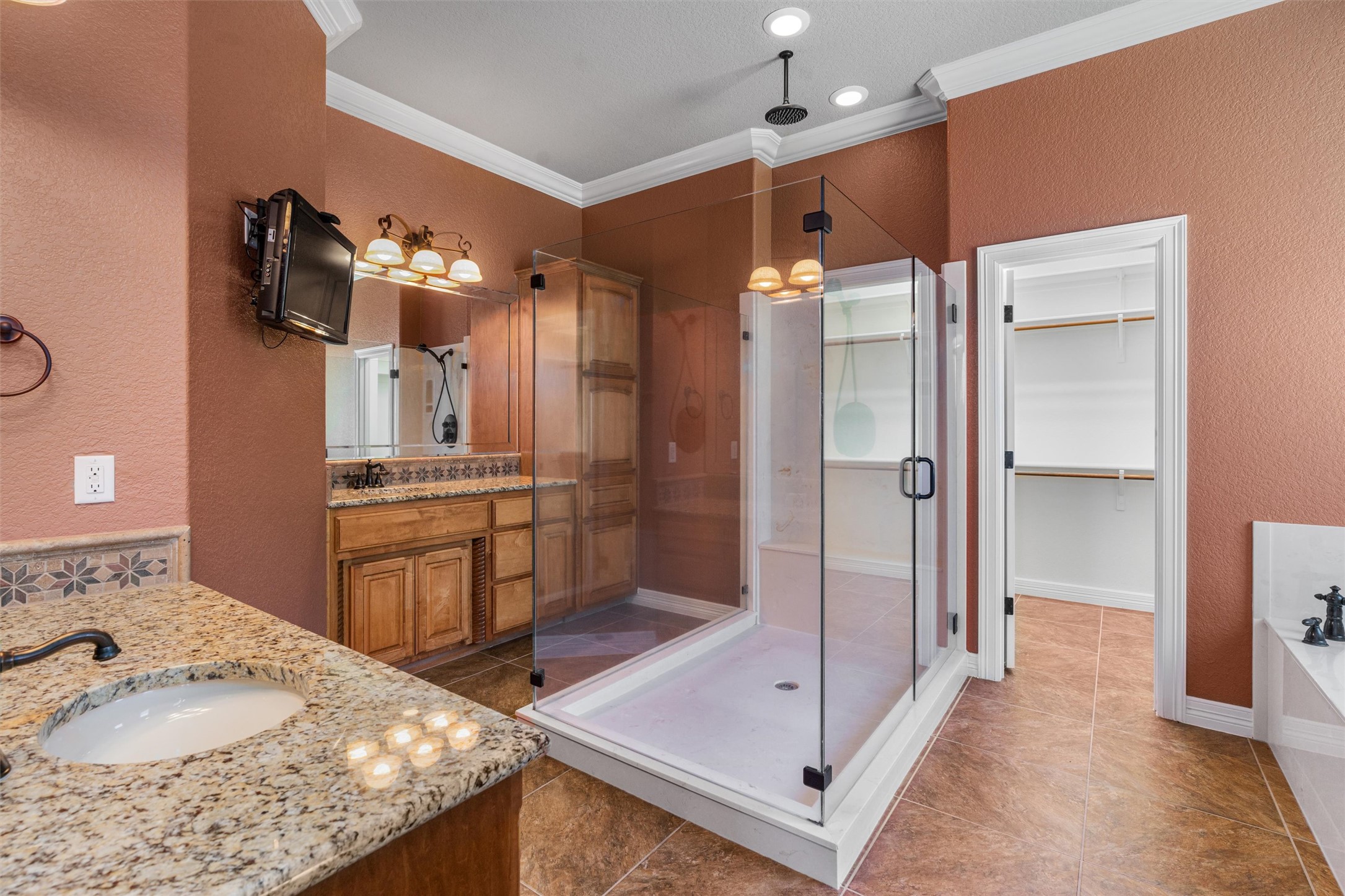 8006 Ridgeway Court Nolanville, TX 76559 - Photo 23 of 40 Full bath with two vanities, a textured wall, crown molding, a spacious closet, and a shower stall