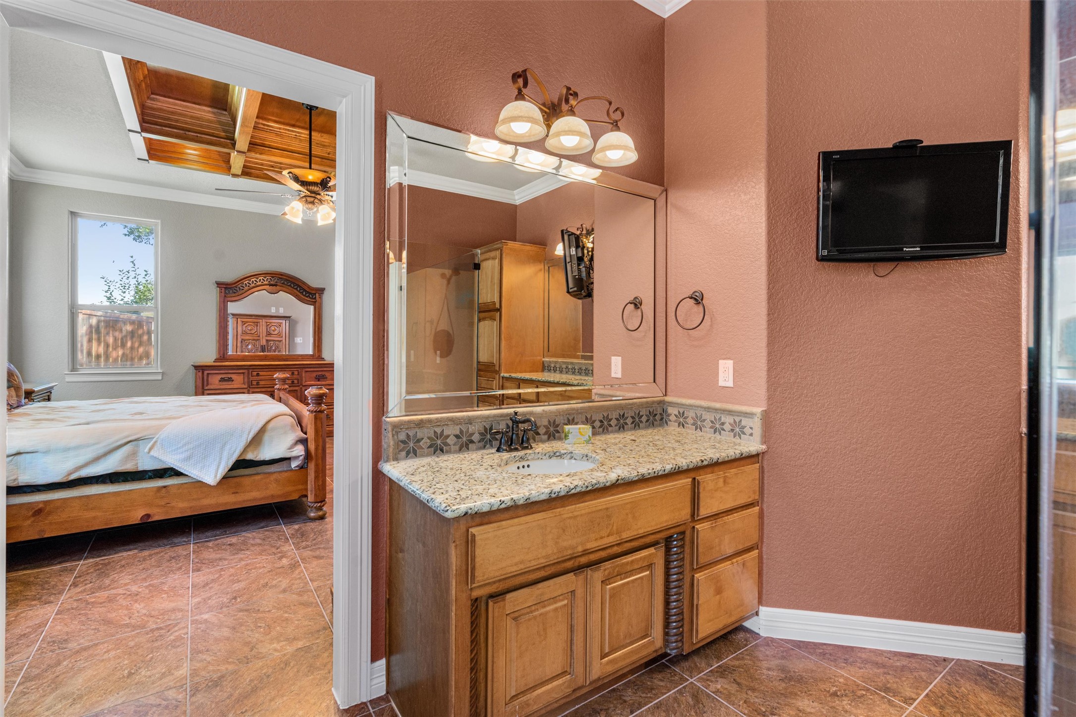 8006 Ridgeway Court Nolanville, TX 76559 - Photo 24 of 40 Ensuite bathroom with a textured wall, vanity, crown molding, ceiling fan, and dark tile patterned flooring