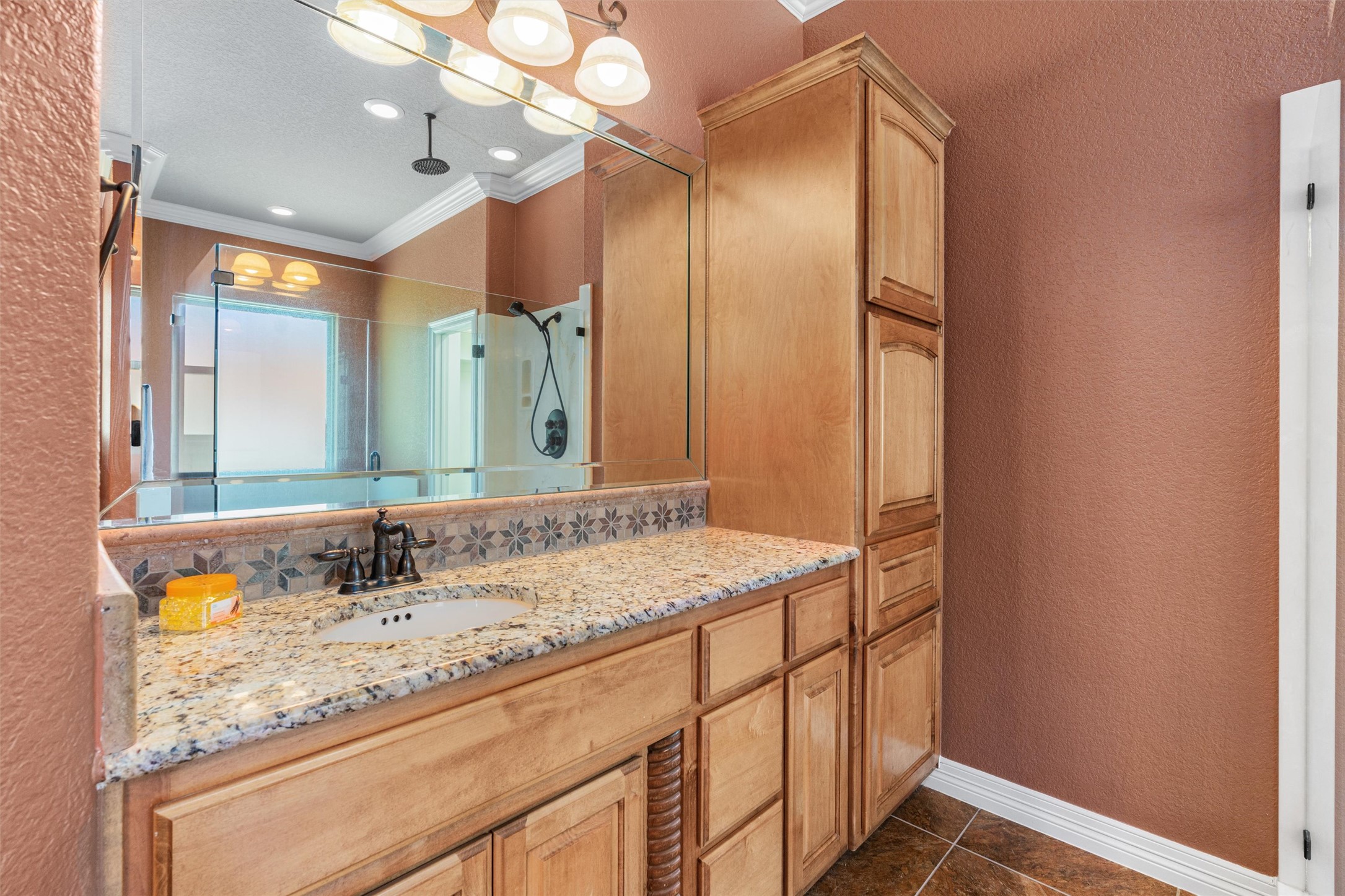 8006 Ridgeway Court Nolanville, TX 76559 - Photo 25 of 40 Full bath featuring a textured wall, vanity, a shower stall, ornamental molding, and dark tile patterned floors