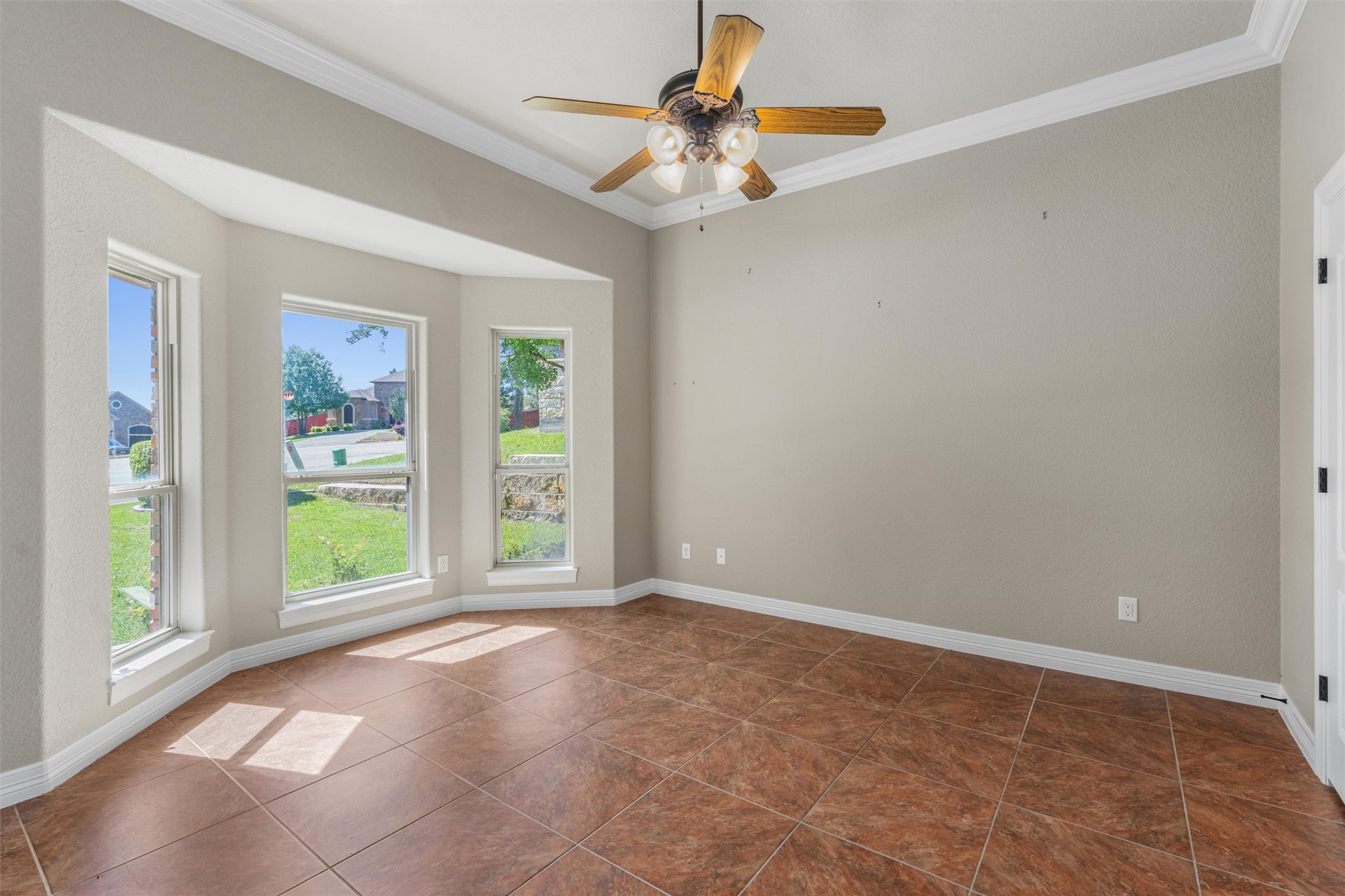 8006 Ridgeway Court Nolanville, TX 76559 - Photo 28 of 40 Unfurnished room with ceiling fan, crown molding, and dark tile patterned flooring