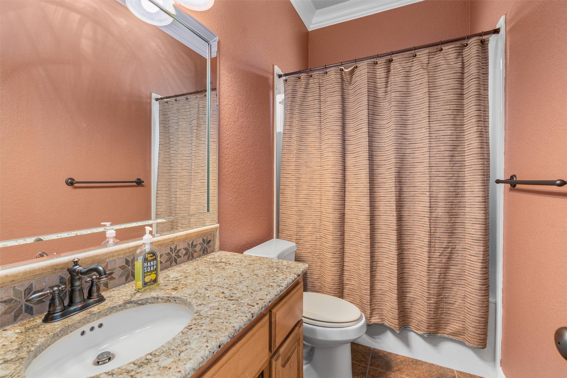 8006 Ridgeway Court Nolanville, TX 76559 - Photo 30 of 40 Bathroom with ornamental molding, vanity, a textured wall, shower / tub combo with curtain, and dark tile patterned flooring