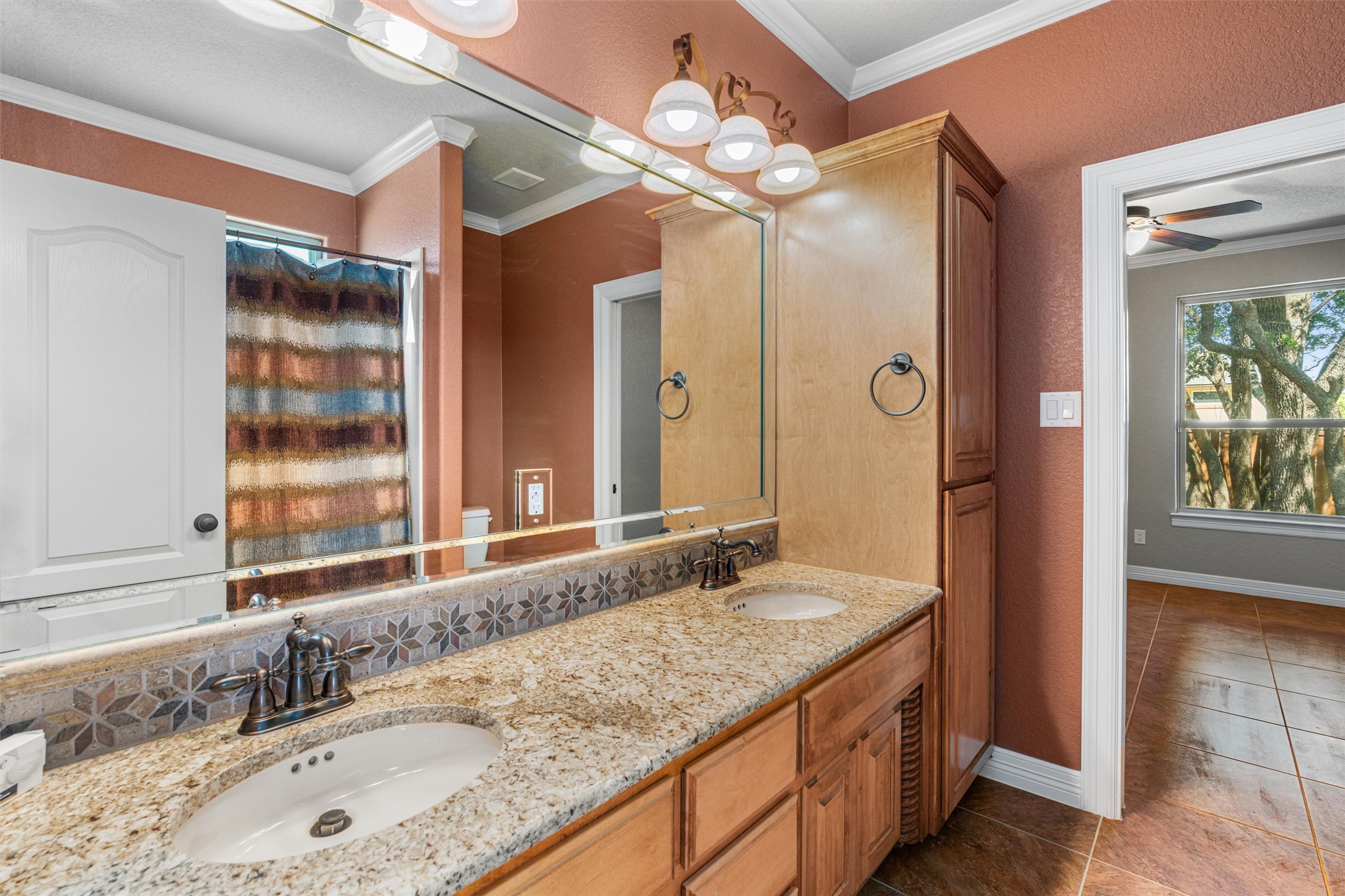 8006 Ridgeway Court Nolanville, TX 76559 - Photo 33 of 40 Full bath with double vanity, crown molding, a shower with shower curtain, light tile patterned floors, and a ceiling fan