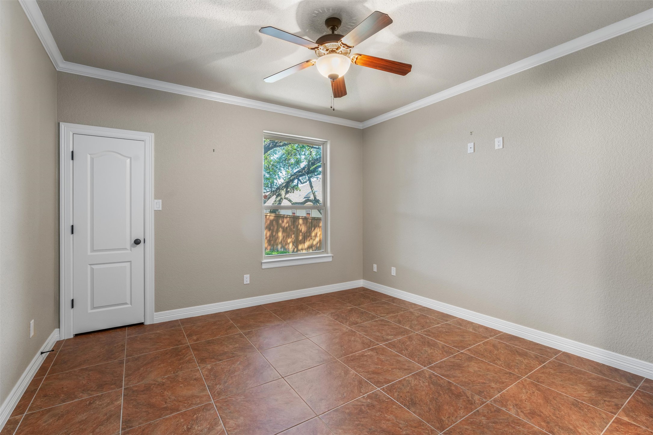 8006 Ridgeway Court Nolanville, TX 76559 - Photo 34 of 40 Spare room with ornamental molding, a ceiling fan, and dark tile patterned flooring