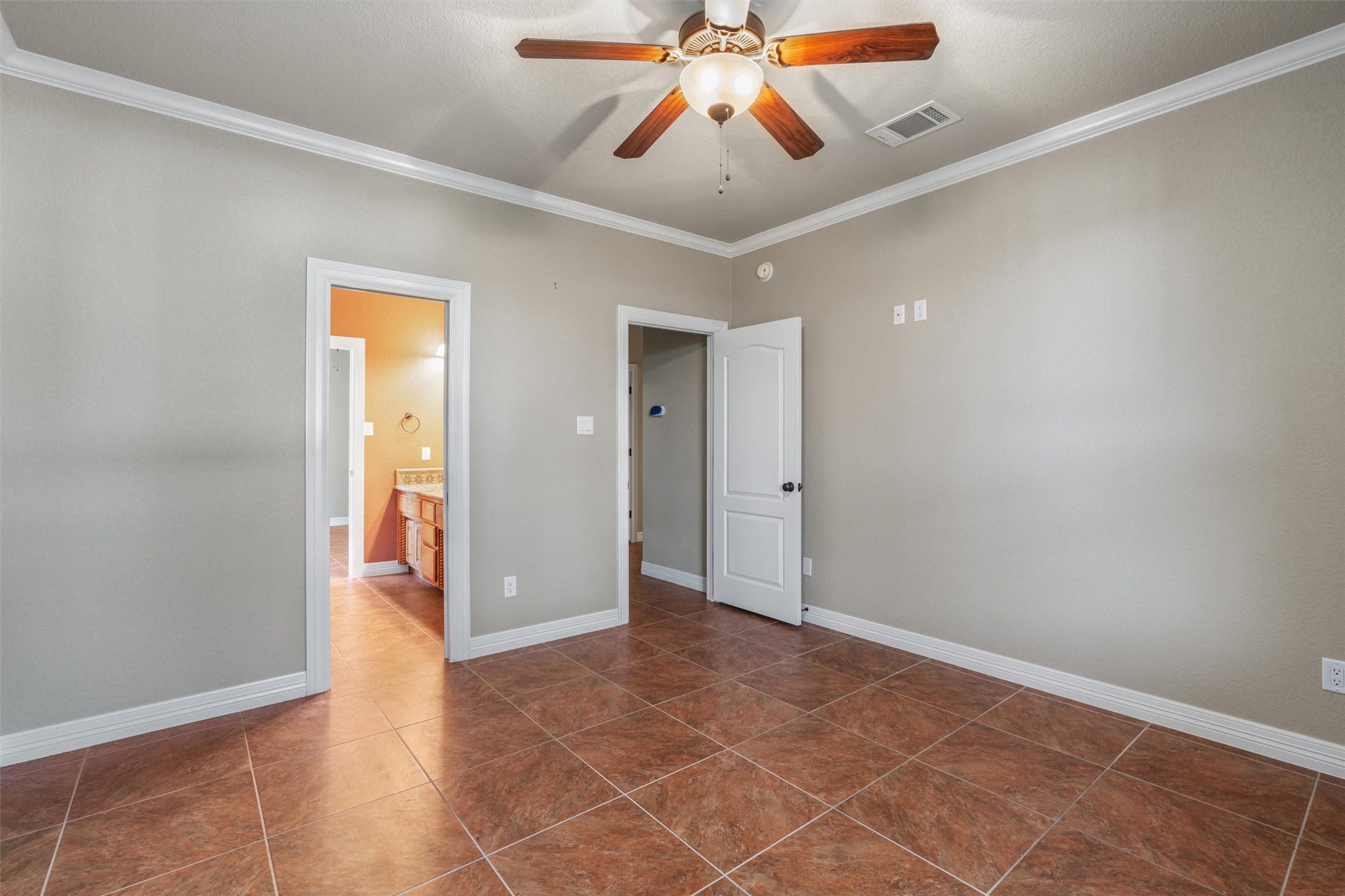8006 Ridgeway Court Nolanville, TX 76559 - Photo 35 of 40 Unfurnished bedroom with ornamental molding, ensuite bathroom, and ceiling fan
