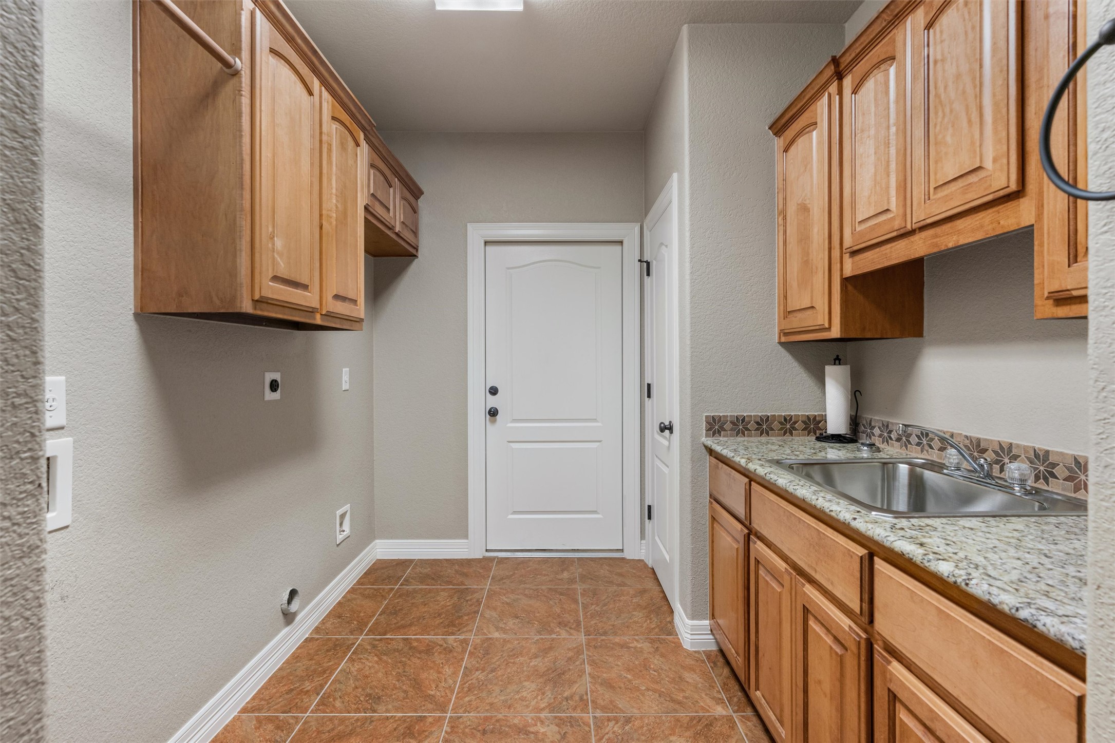 8006 Ridgeway Court Nolanville, TX 76559 - Photo 36 of 40 Laundry area featuring cabinet space, a textured wall, and hookup for an electric dryer