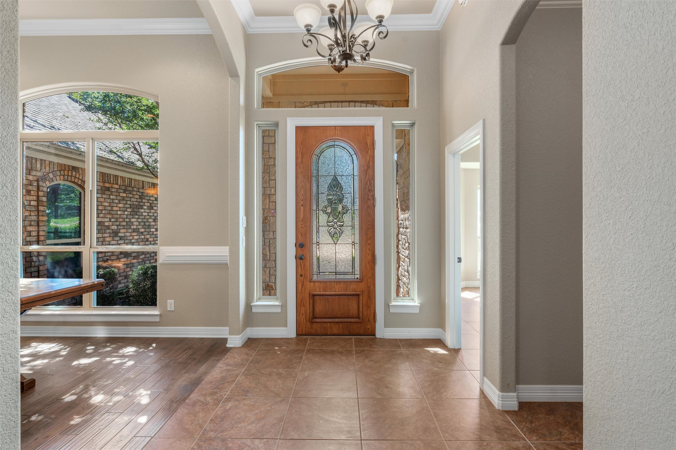 8006 Ridgeway Court Nolanville, TX 76559 - Photo 5 of 40 Tiled foyer with arched walkways, healthy amount of natural light, a chandelier, and ornamental molding