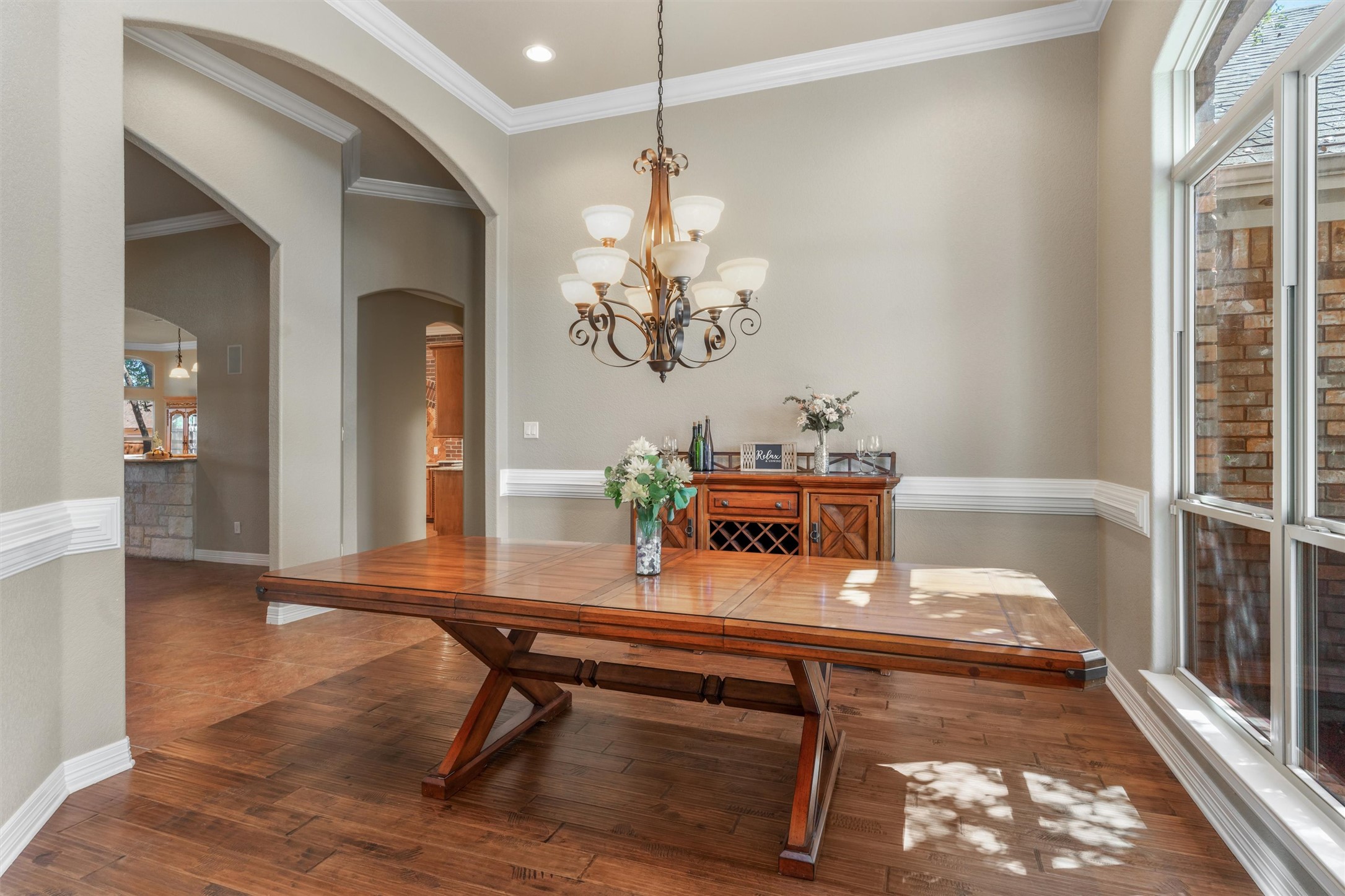 8006 Ridgeway Court Nolanville, TX 76559 - Photo 7 of 40 Dining room featuring crown molding, hanging lights, hardwood / wood-style floors, and arched walkways