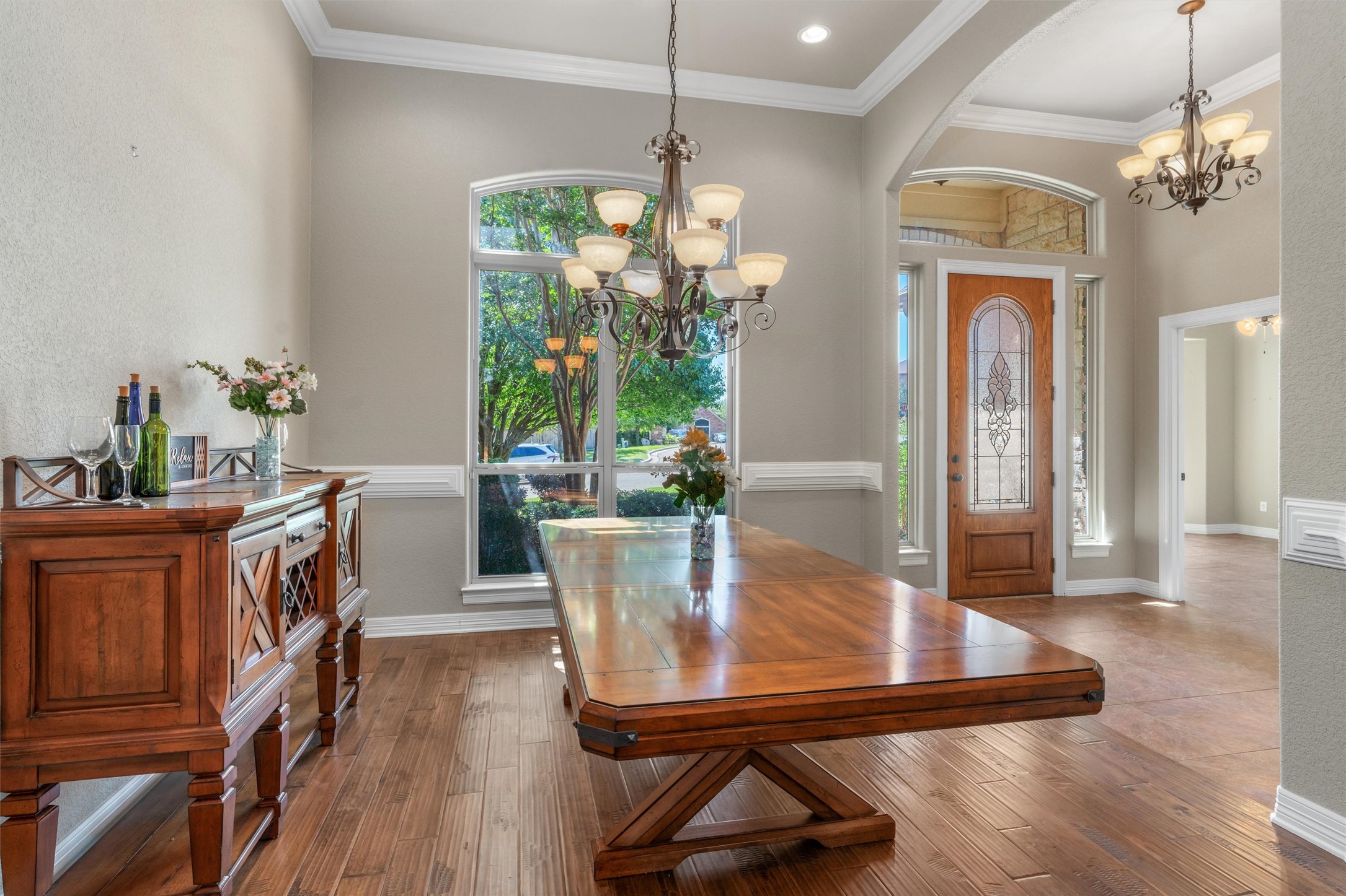 8006 Ridgeway Court Nolanville, TX 76559 - Photo 8 of 40 Entrance foyer with a chandelier, wood-type flooring, crown molding, arched walkways, and a textured wall