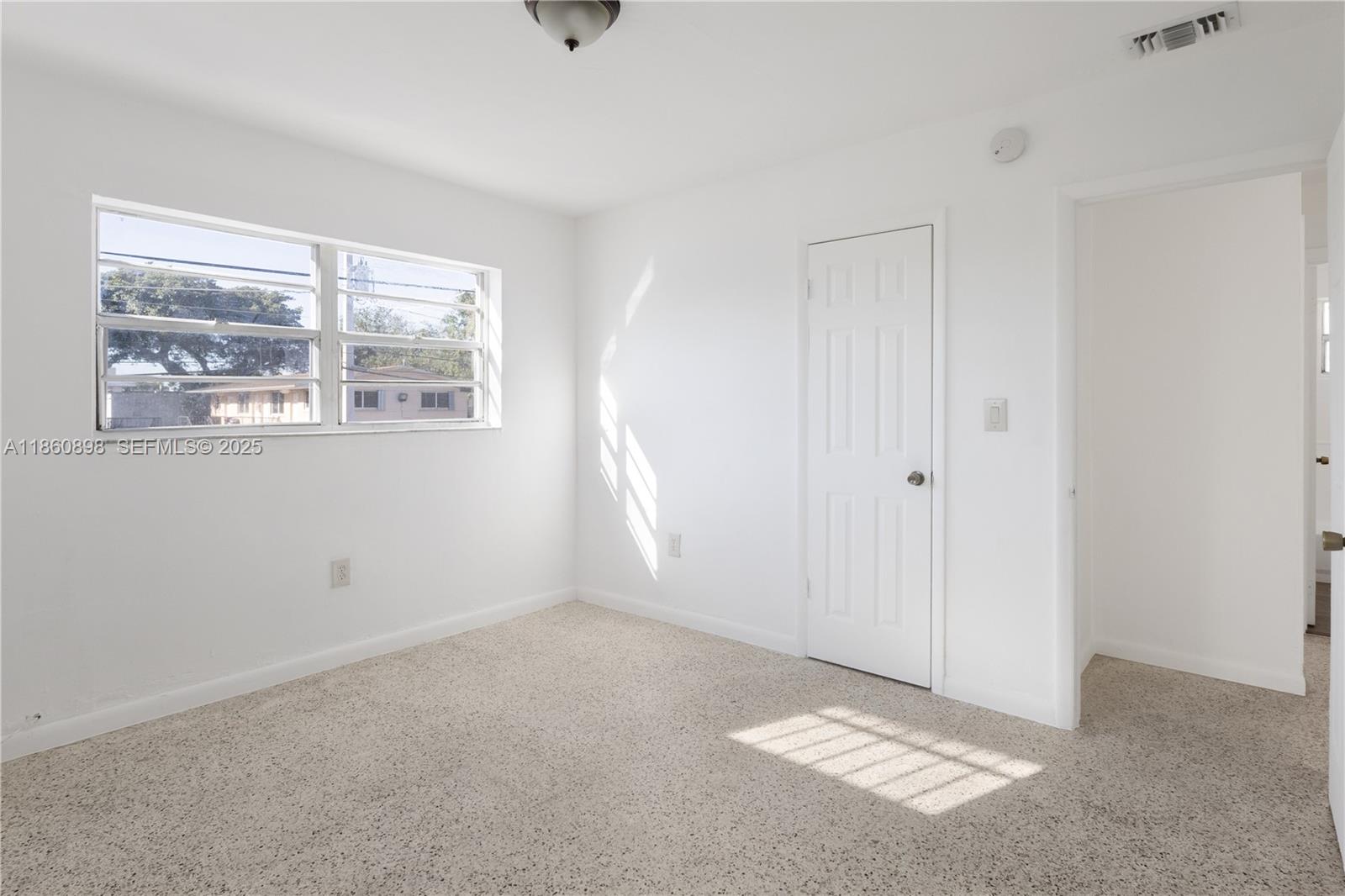 1251 Northwest 59th Street, Unit 3 Miami, FL 33142 - Photo 15 of 22 a view of an empty room with a window