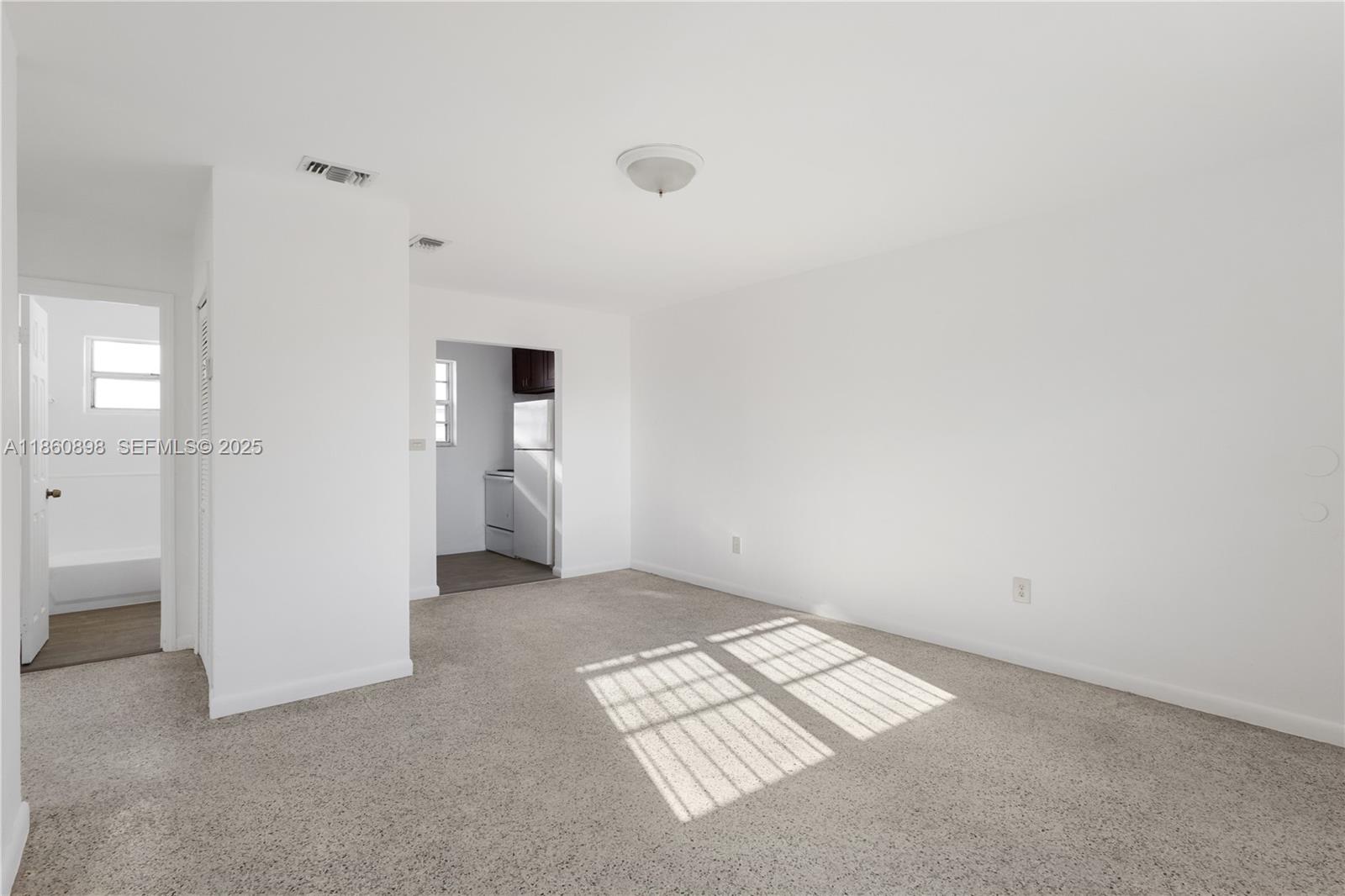1251 Northwest 59th Street, Unit 3 Miami, FL 33142 - Photo 2 of 22 an empty room with windows and closet