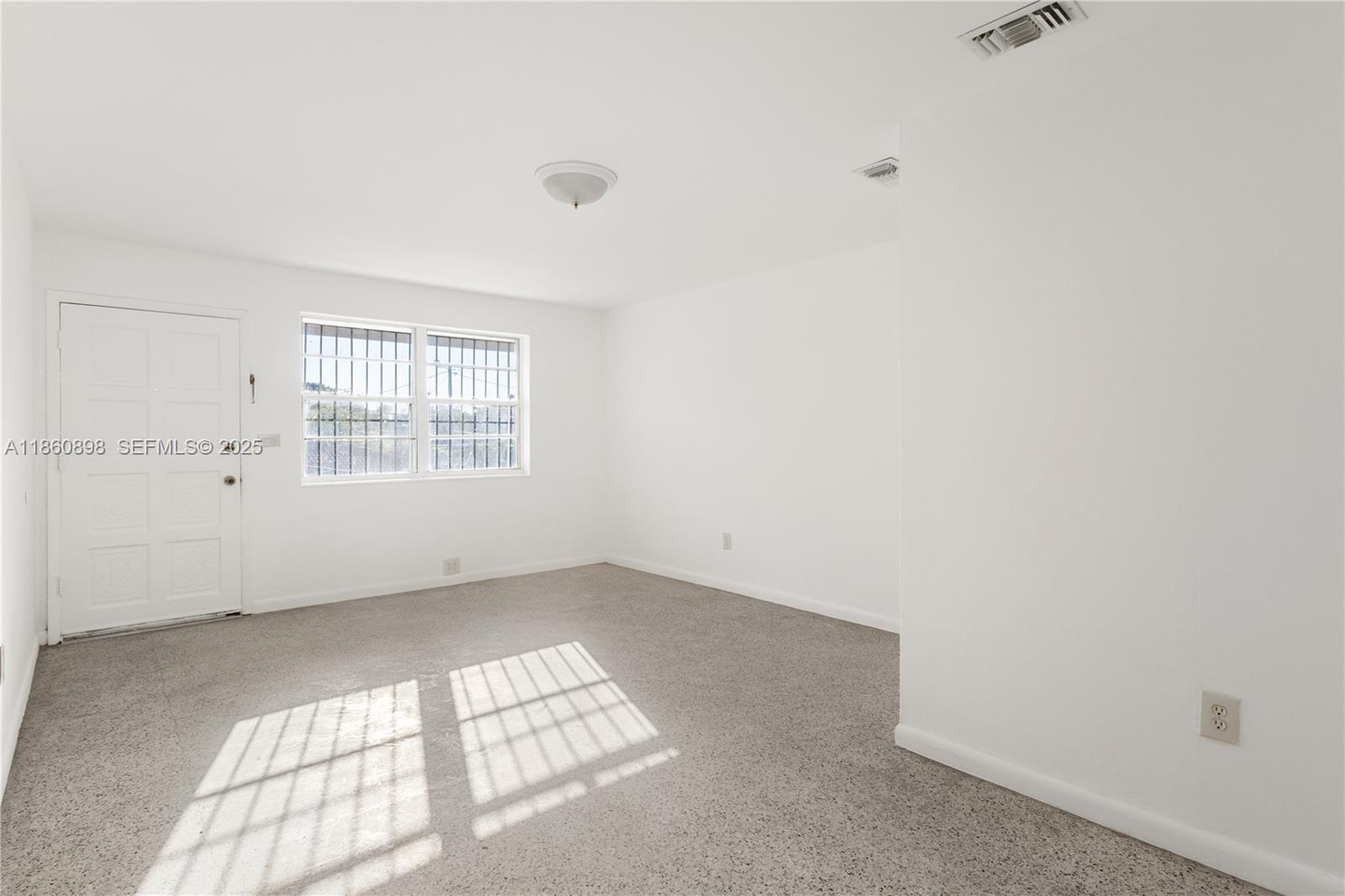 1251 Northwest 59th Street, Unit 3 Miami, FL 33142 - Photo 3 of 22 an empty room with windows