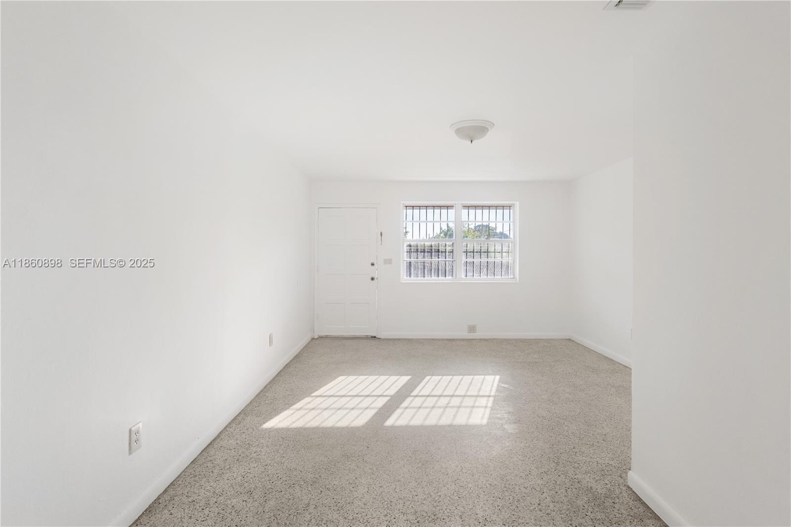 1251 Northwest 59th Street, Unit 3 Miami, FL 33142 - Photo 6 of 22 an empty room with windows