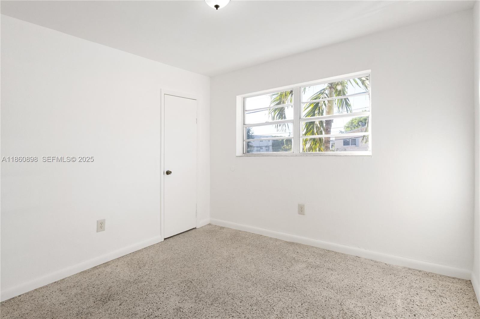 1251 Northwest 59th Street, Unit 3 Miami, FL 33142 - Photo 8 of 22 a view of an empty room with a window