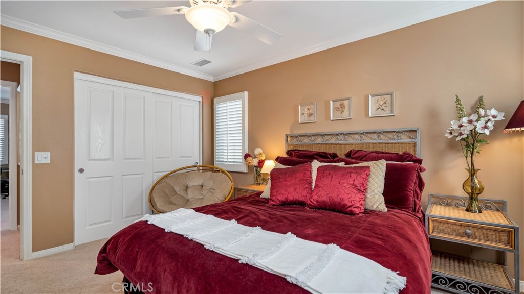 55 Bower Tree Irvine, CA 92603 - Photo 12 of 29 a bedroom with a bed and a chandelier