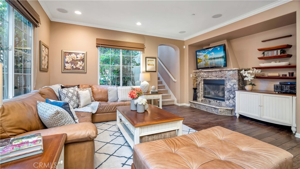 55 Bower Tree Irvine, CA 92603 - Photo 24 of 29 a living room with furniture a flat screen tv and a fireplace