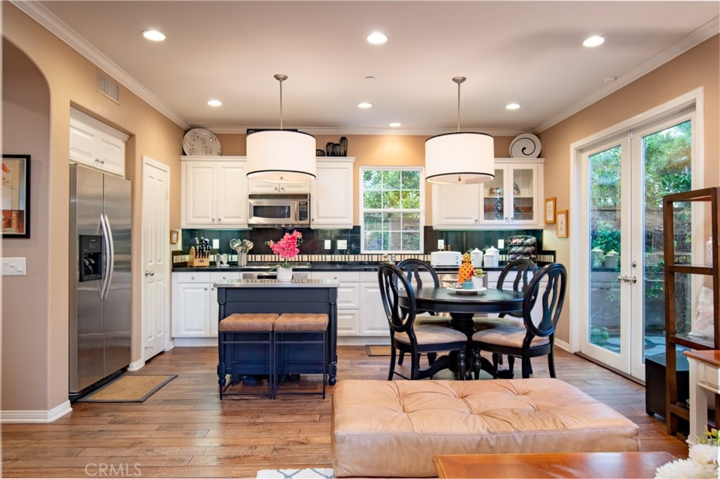 55 Bower Tree Irvine, CA 92603 - Photo 6 of 29 a kitchen with stainless steel appliances granite countertop a stove a refrigerator a kitchen island a table and chairs