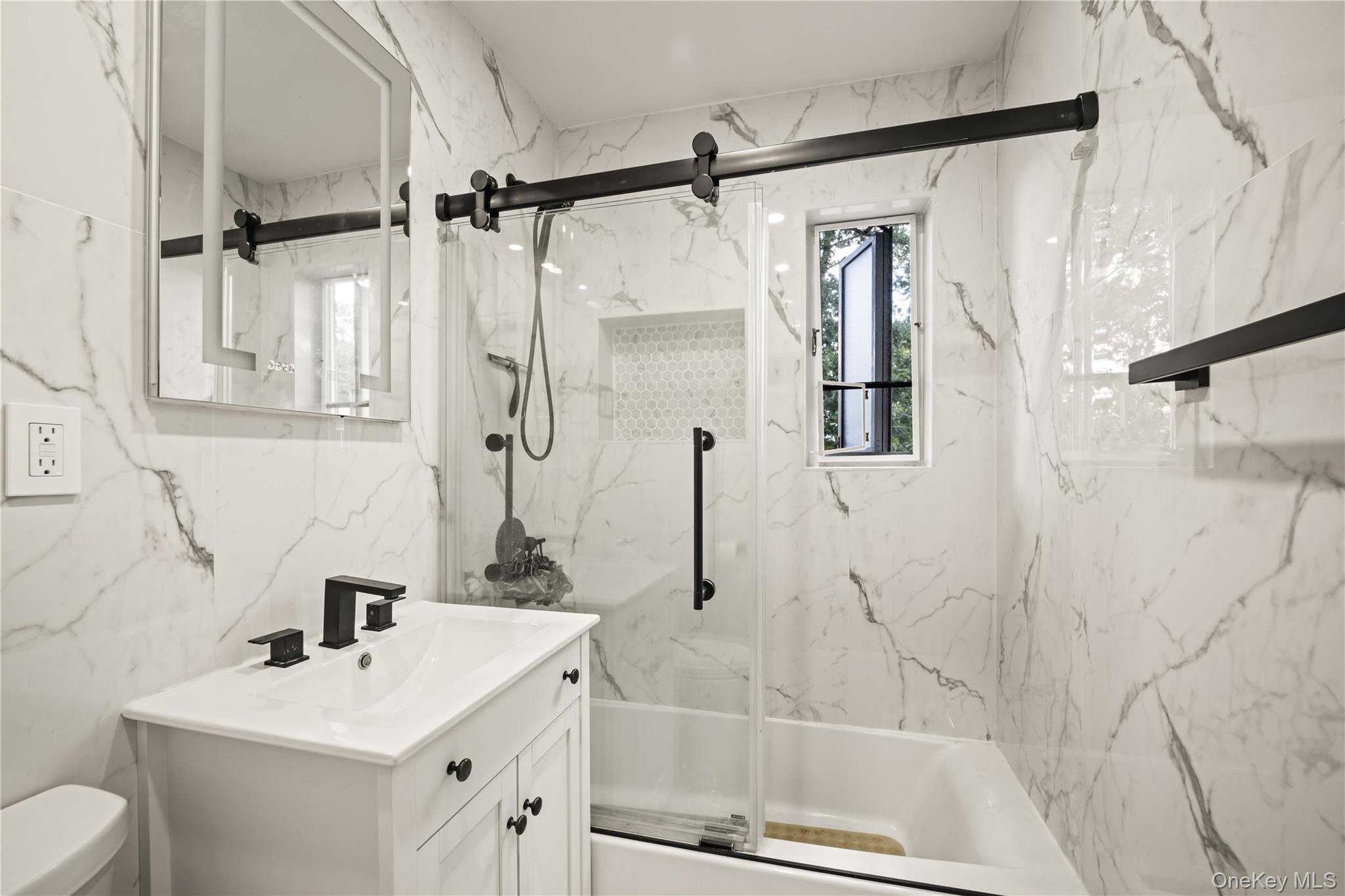 223-11 Manor Road, Unit UPPR Queens, NY 11427 - Photo 13 of 16 a bathroom with a sink vanity granite tub shower and mirror