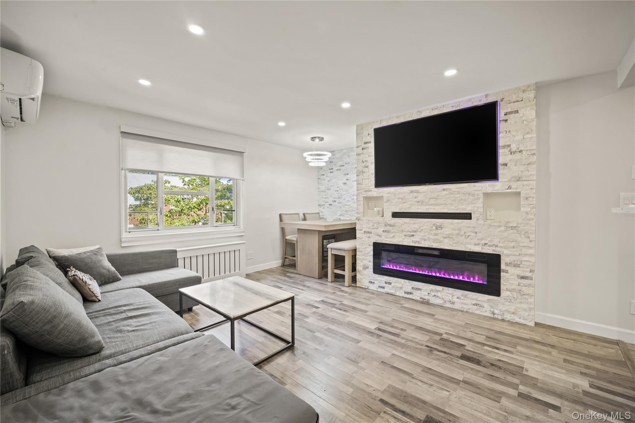 223-11 Manor Road, Unit UPPR Queens, NY 11427 - Photo 2 of 16 a living room with furniture and a flat screen tv