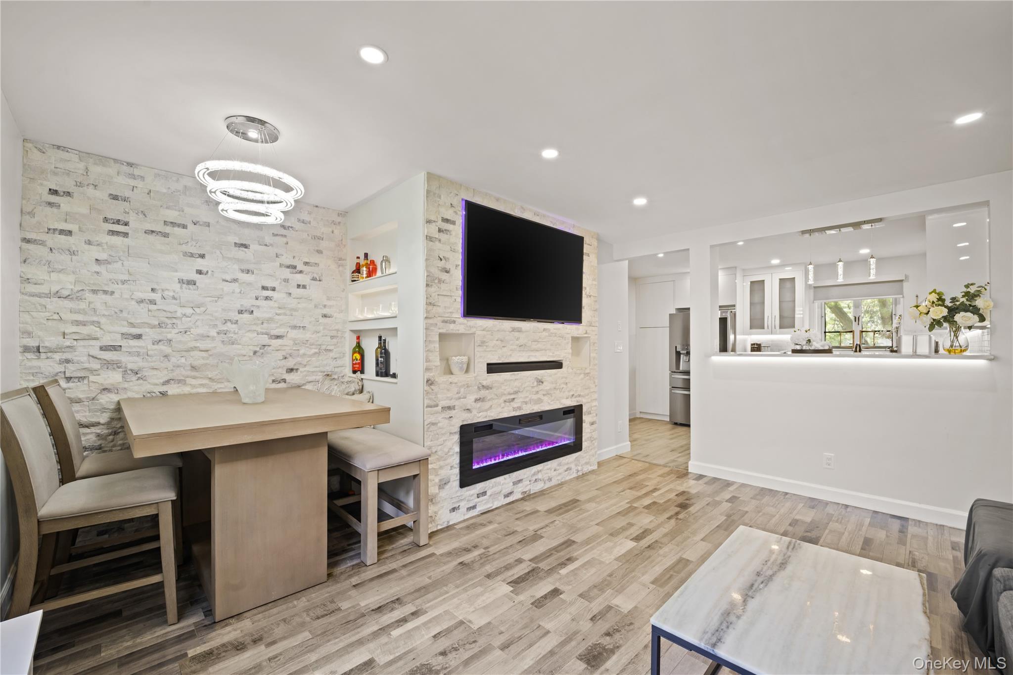 223-11 Manor Road, Unit UPPR Queens, NY 11427 - Photo 4 of 16 a living room with stainless steel appliances kitchen island granite countertop a sink and a flat screen tv