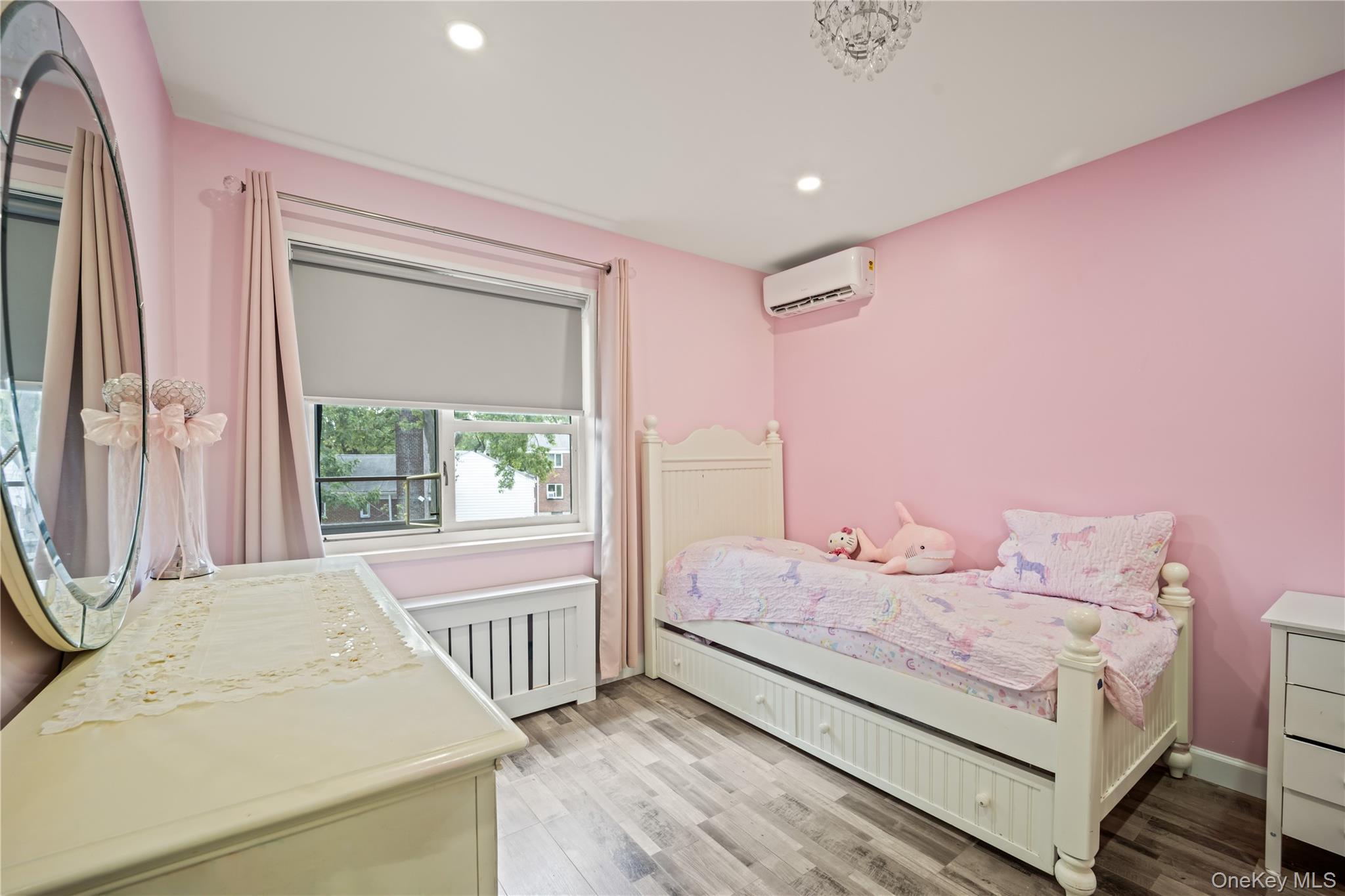 223-11 Manor Road, Unit UPPR Queens, NY 11427 - Photo 8 of 16 a bedroom with a bed and a window