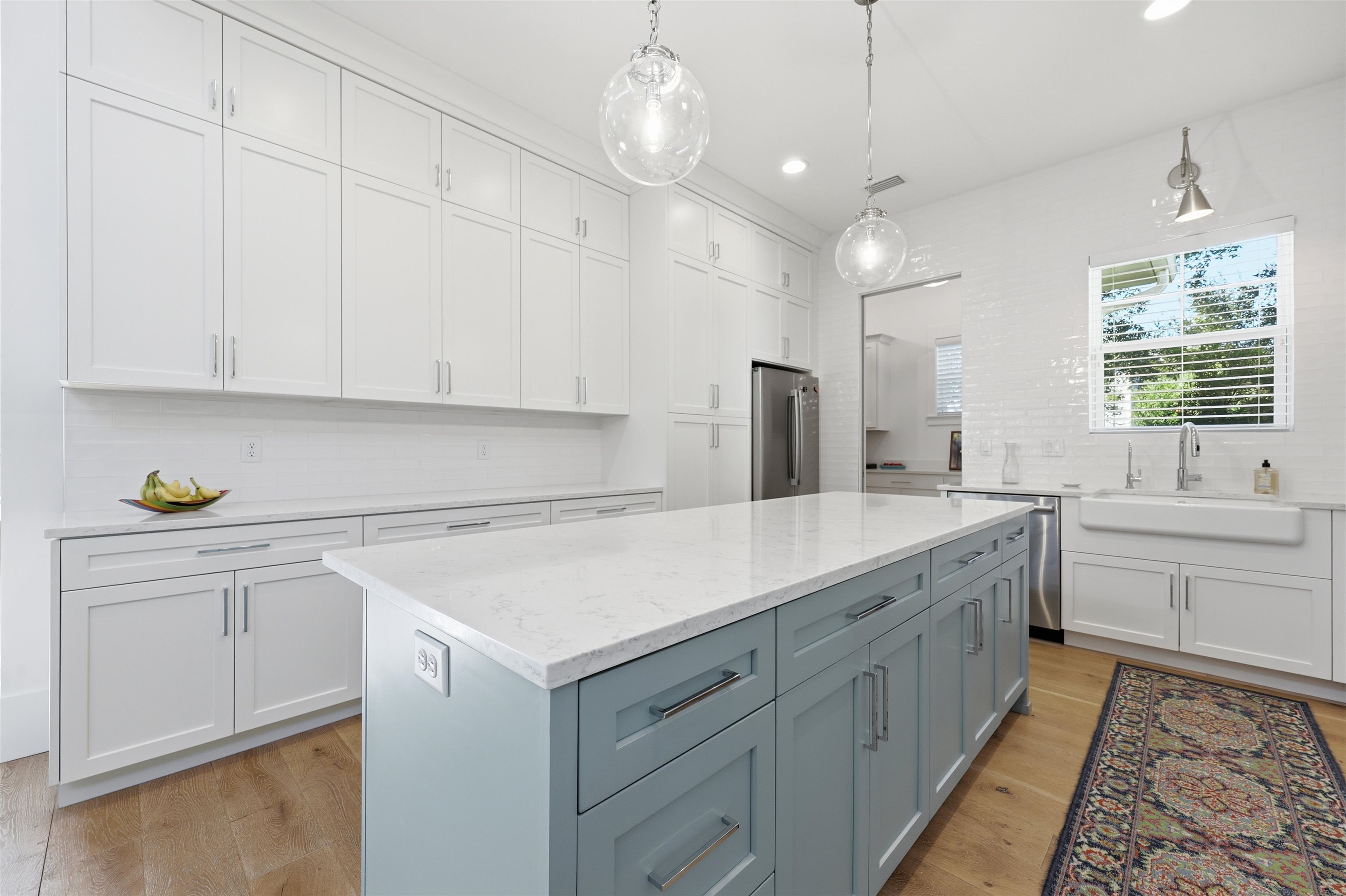 66 Ridgeway Road St. Augustine, FL 32080 - Photo 11 of 53 Kitchen featuring backsplash, light wood finished floors, light stone counters, hanging light fixtures, and recessed lighting