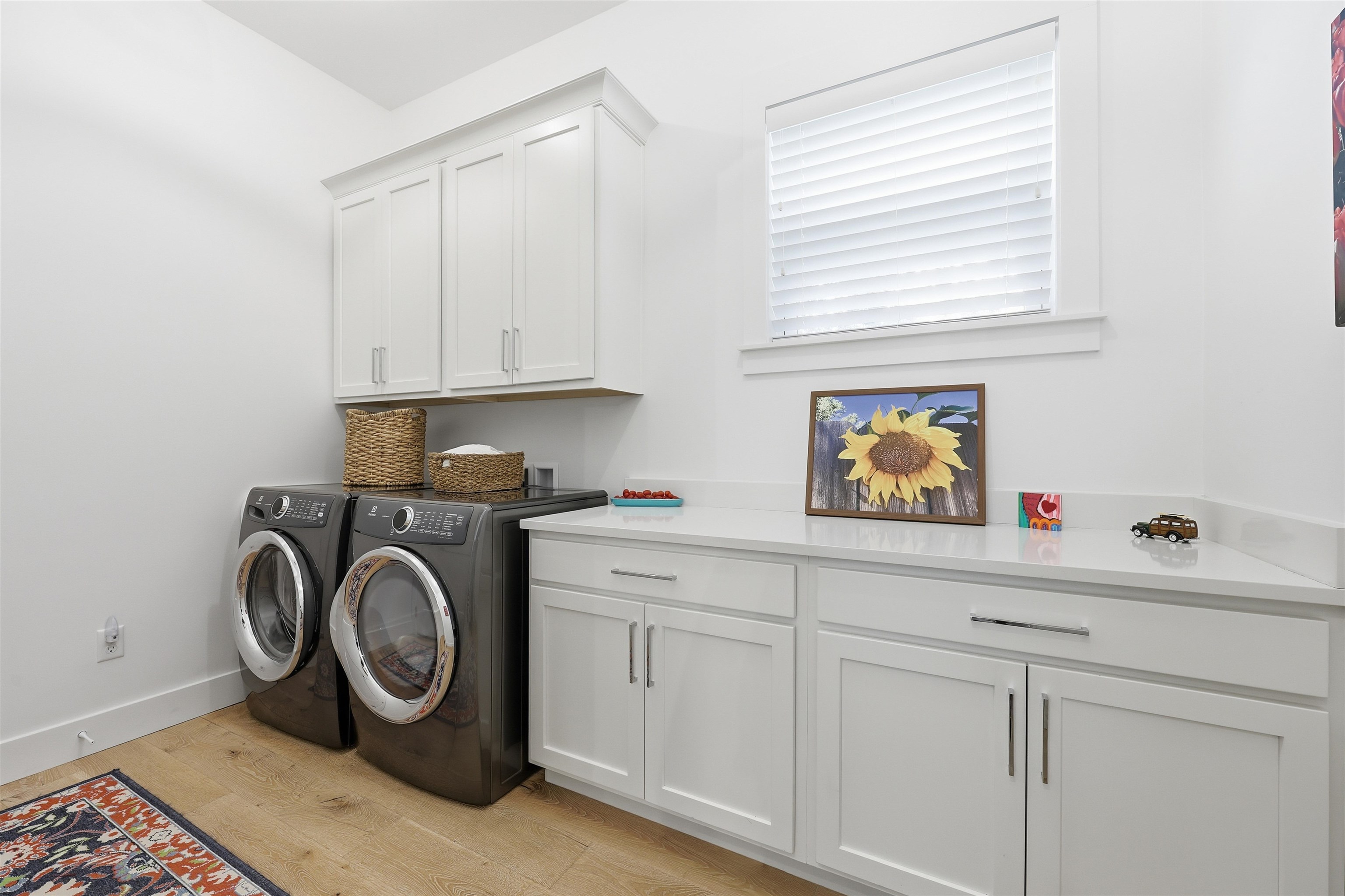 66 Ridgeway Road St. Augustine, FL 32080 - Photo 25 of 53 Washroom with light wood finished floors, washer and clothes dryer, and cabinet space