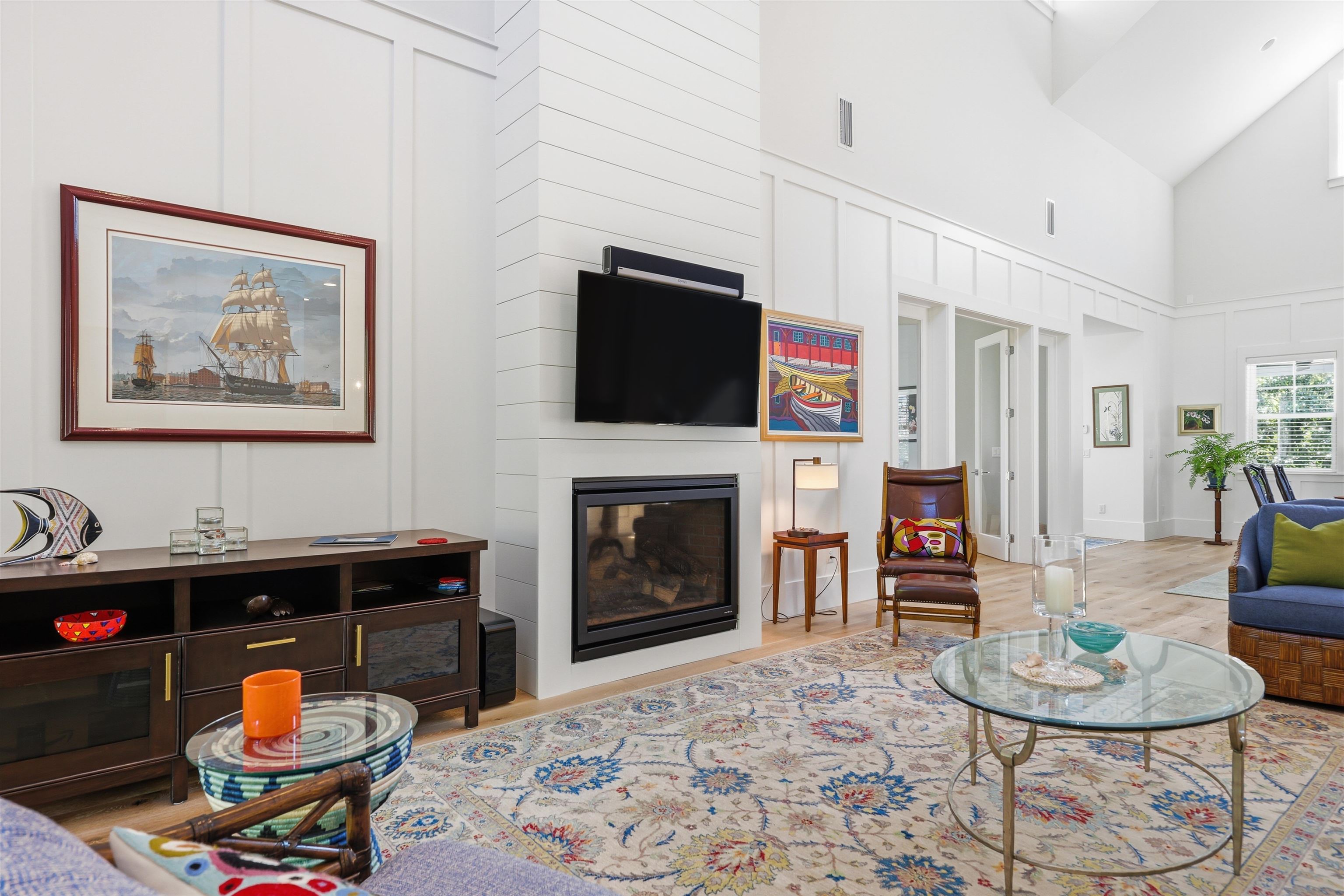 66 Ridgeway Road St. Augustine, FL 32080 - Photo 41 of 53 Living room with light wood-style floors, a large fireplace, high vaulted ceiling, and a decorative wall