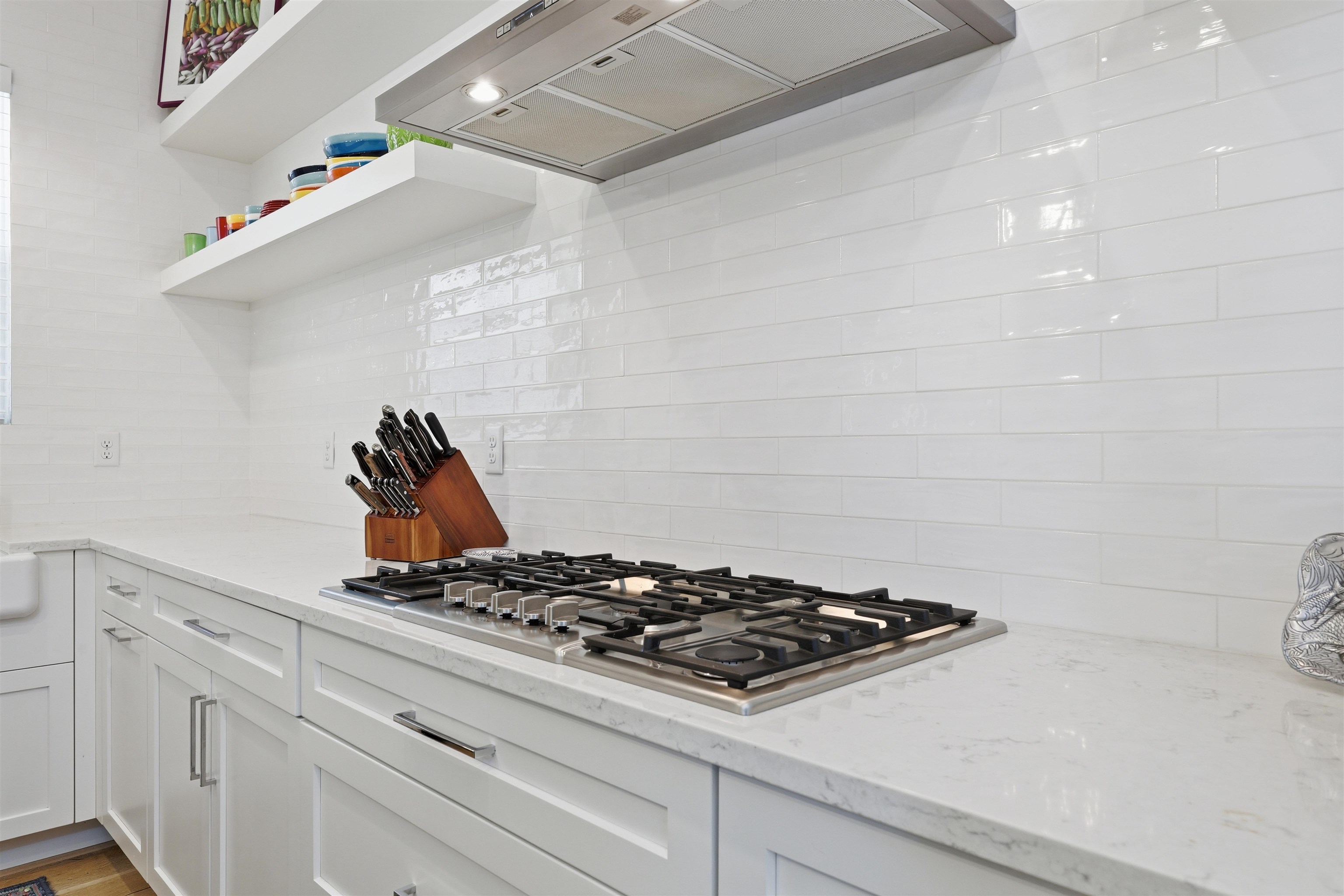 66 Ridgeway Road St. Augustine, FL 32080 - Photo 42 of 53 Kitchen with open shelves, custom exhaust hood, light stone counters, and stainless steel gas stovetop