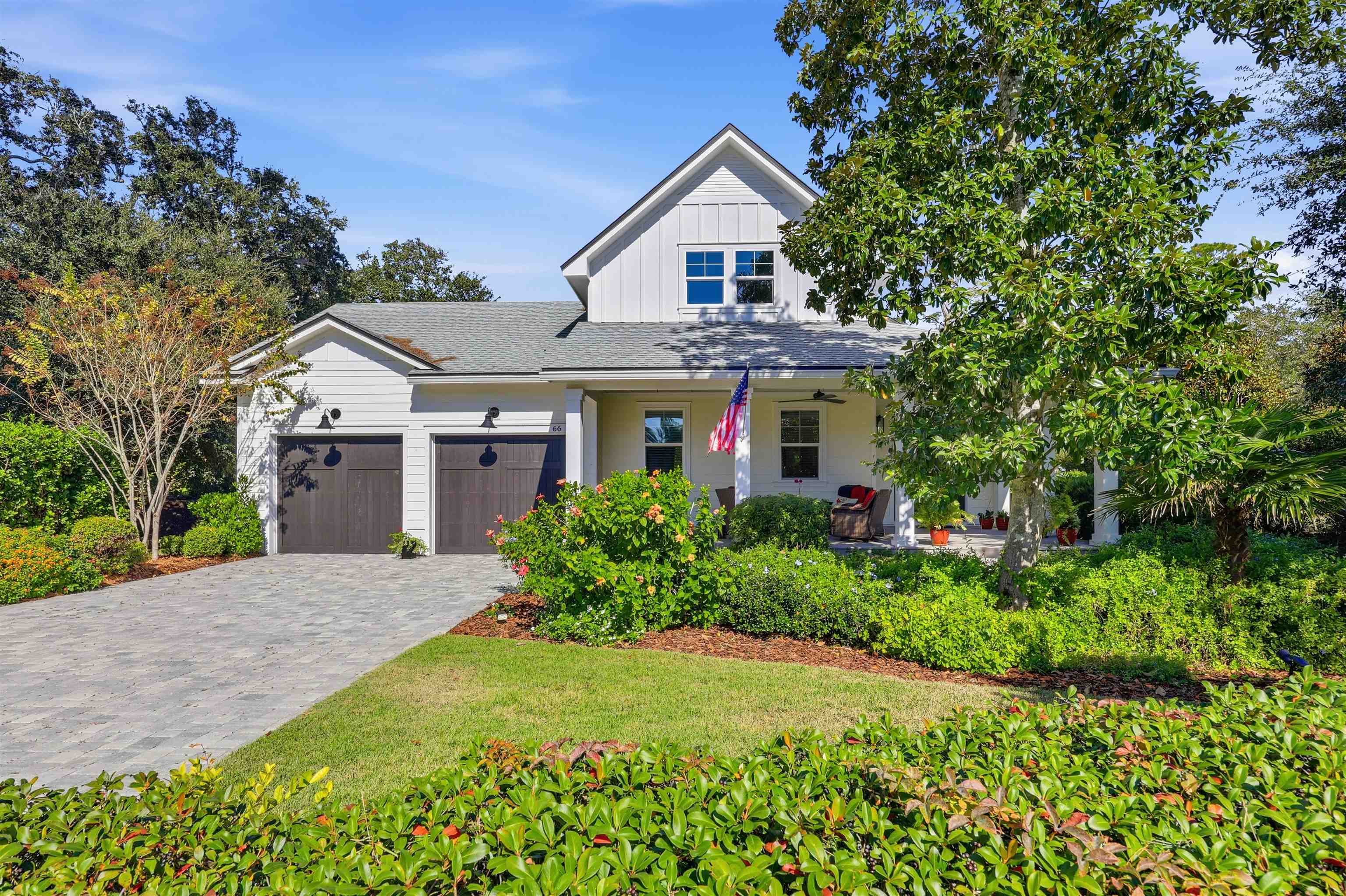 66 Ridgeway Road St. Augustine, FL 32080 - Photo 46 of 53 View of front of home featuring board and batten siding, covered porch, decorative driveway, an attached garage, and roof with shingles