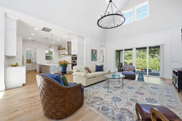 a living room with furniture and floor to ceiling windows