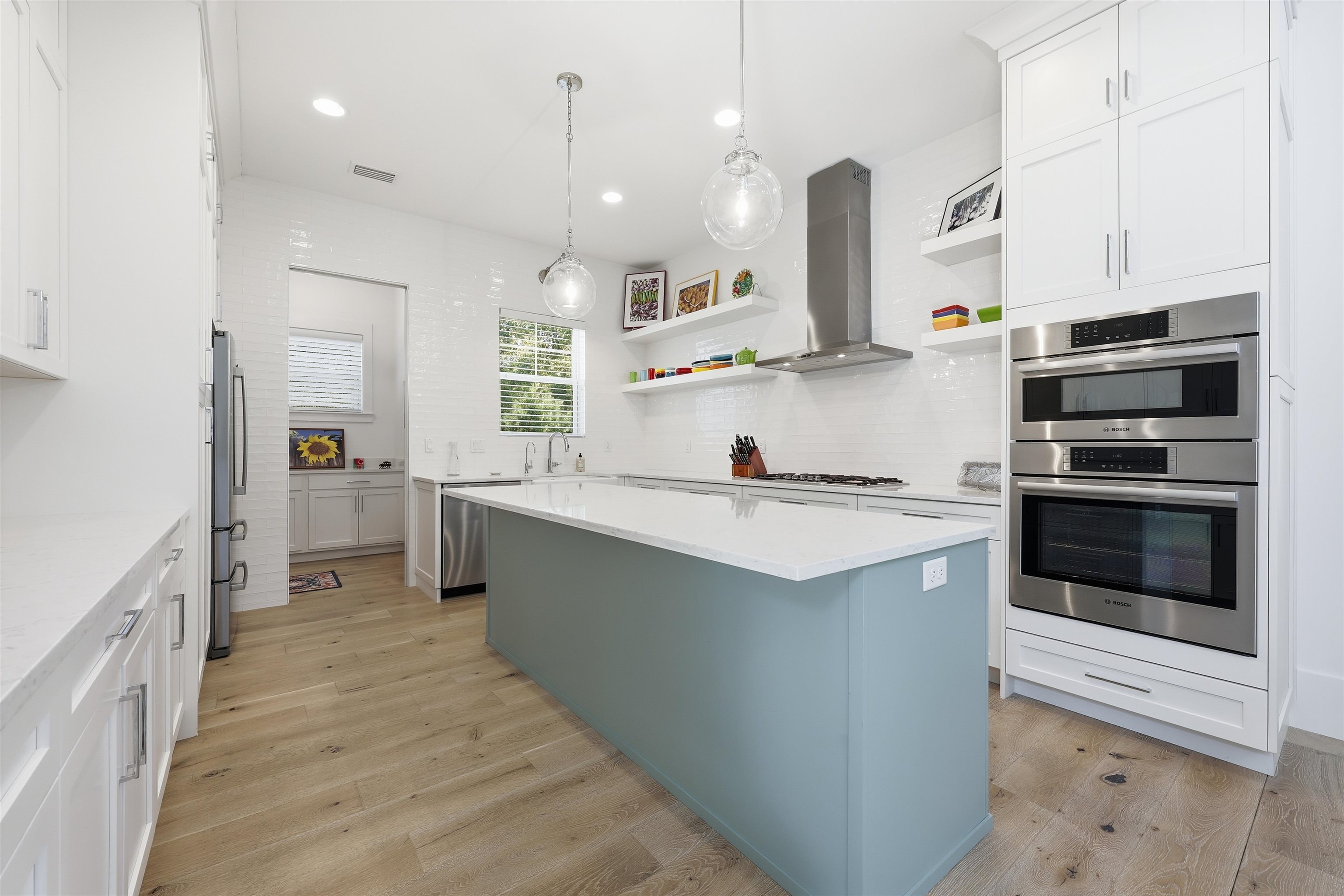 66 Ridgeway Road St. Augustine, FL 32080 - Photo 8 of 53 a large kitchen with stainless steel appliances kitchen island granite countertop a stove top oven a sink dishwasher and a refrigerator with wooden floor
