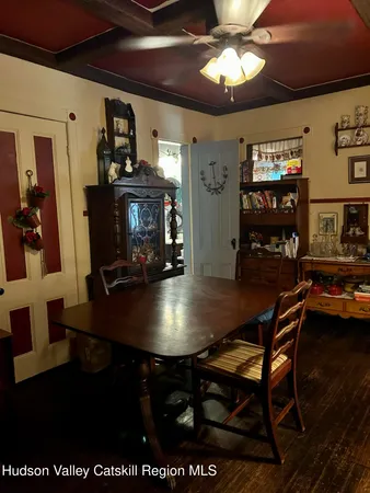 a dining room with furniture and wooden floor