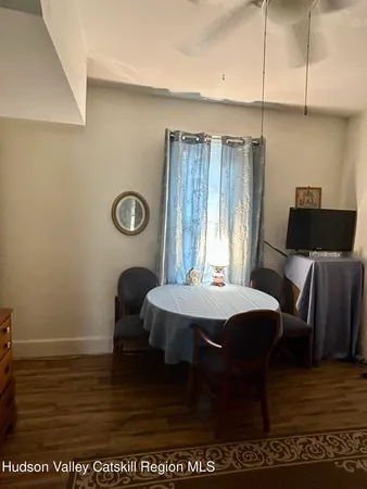 a dining room with furniture and wooden floor