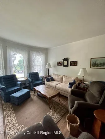 a living room with furniture potted plant and a window