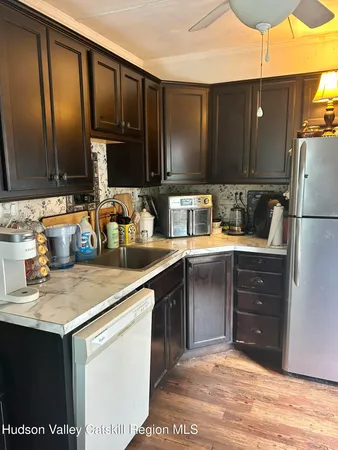 a kitchen with a sink cabinets and stainless steel appliances
