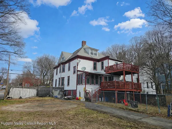 a view of a white building with large windows