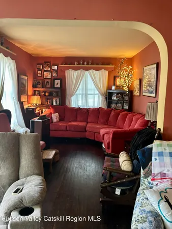 a living room with furniture and a floor to ceiling window