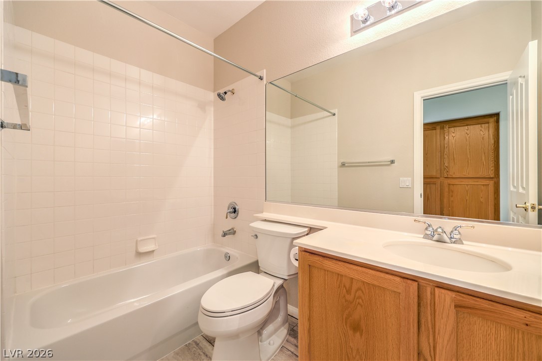 3713 Spring Shadow Road Las Vegas, NV 89129 - Photo 30 of 37 This bathroom features a full-sized tub and a spacious vanity with an integrated sink and large mirror.