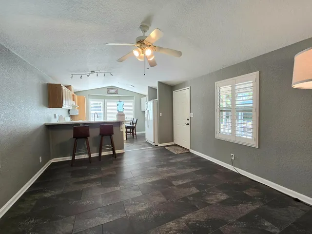 a view of a livingroom with furniture window and wooden floor