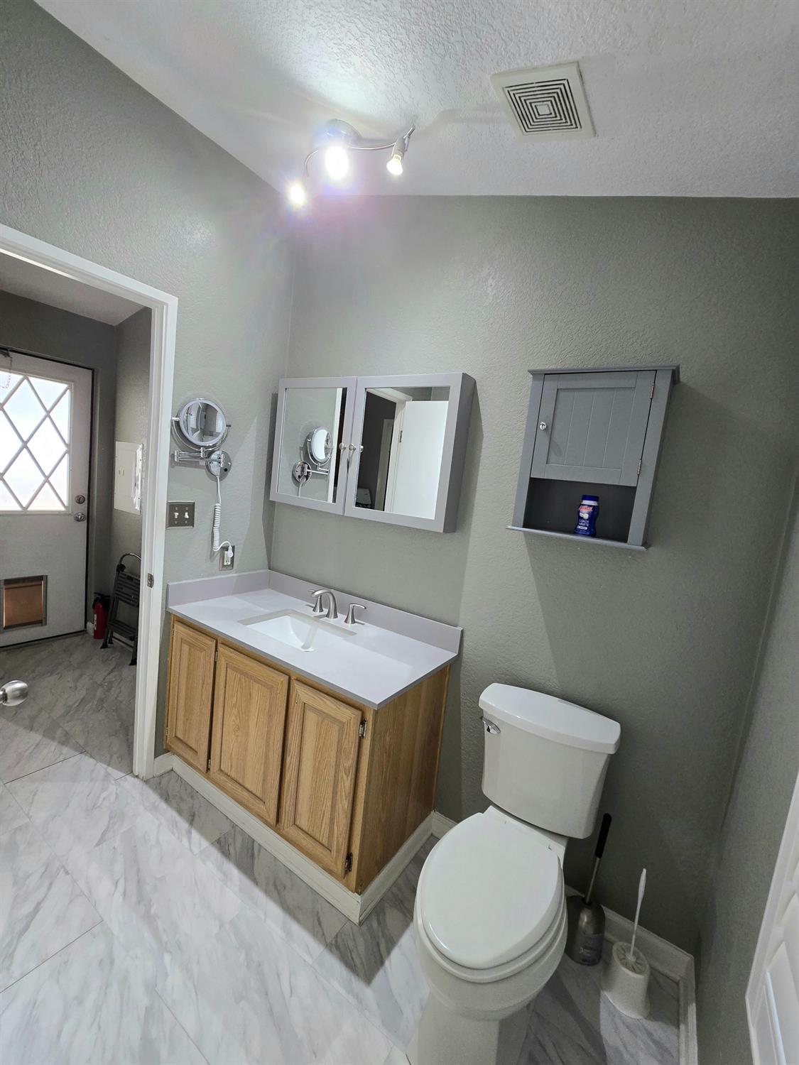 13955 West Walnut Grove Road, Unit 26 Walnut Grove, CA 95690 - Photo 15 of 29 a bathroom with a toilet sink and mirror