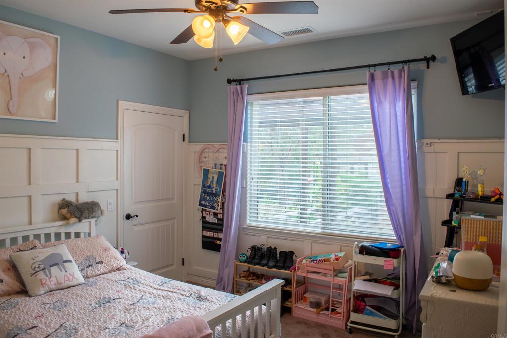 2521 Ralls Street Fallbrook, CA 92028 - Photo 21 of 43 a bedroom with a bed and a chandelier