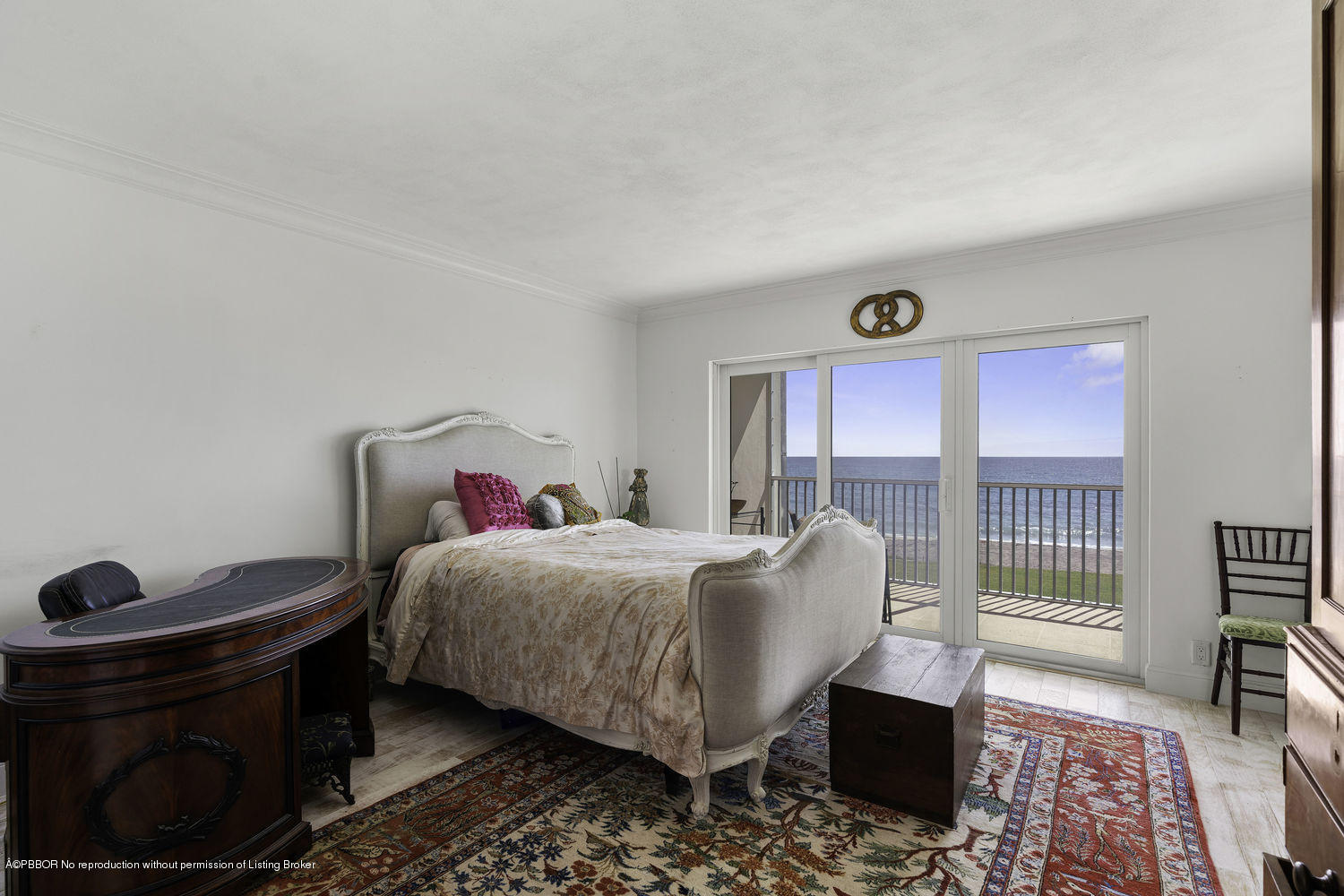 250 South Beach Road, Unit 208 Jupiter, FL 33469 - Photo 8 of 14 a bedroom with a bed and a table in it