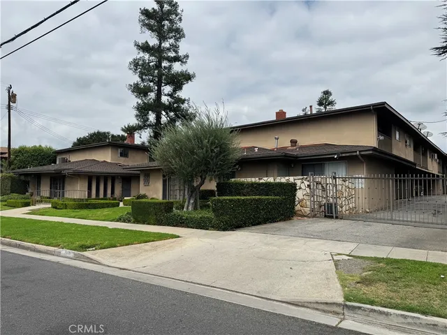a view of a house with a yard and plants